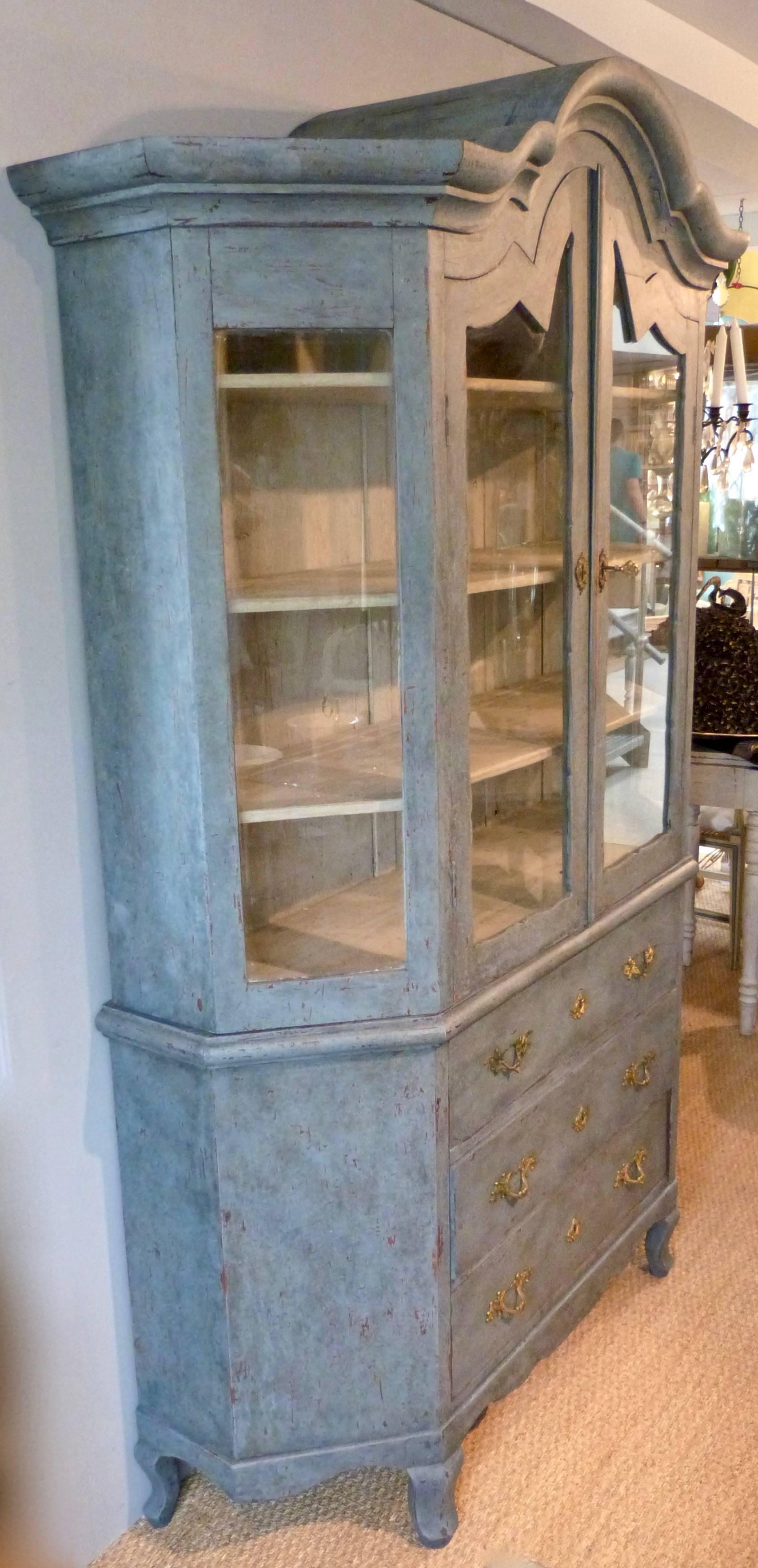 A 19th century Gustavian Style display cabinet with glass doors and upper side panels and three drawers to the base, Swedish, circa 1850. Later painted.