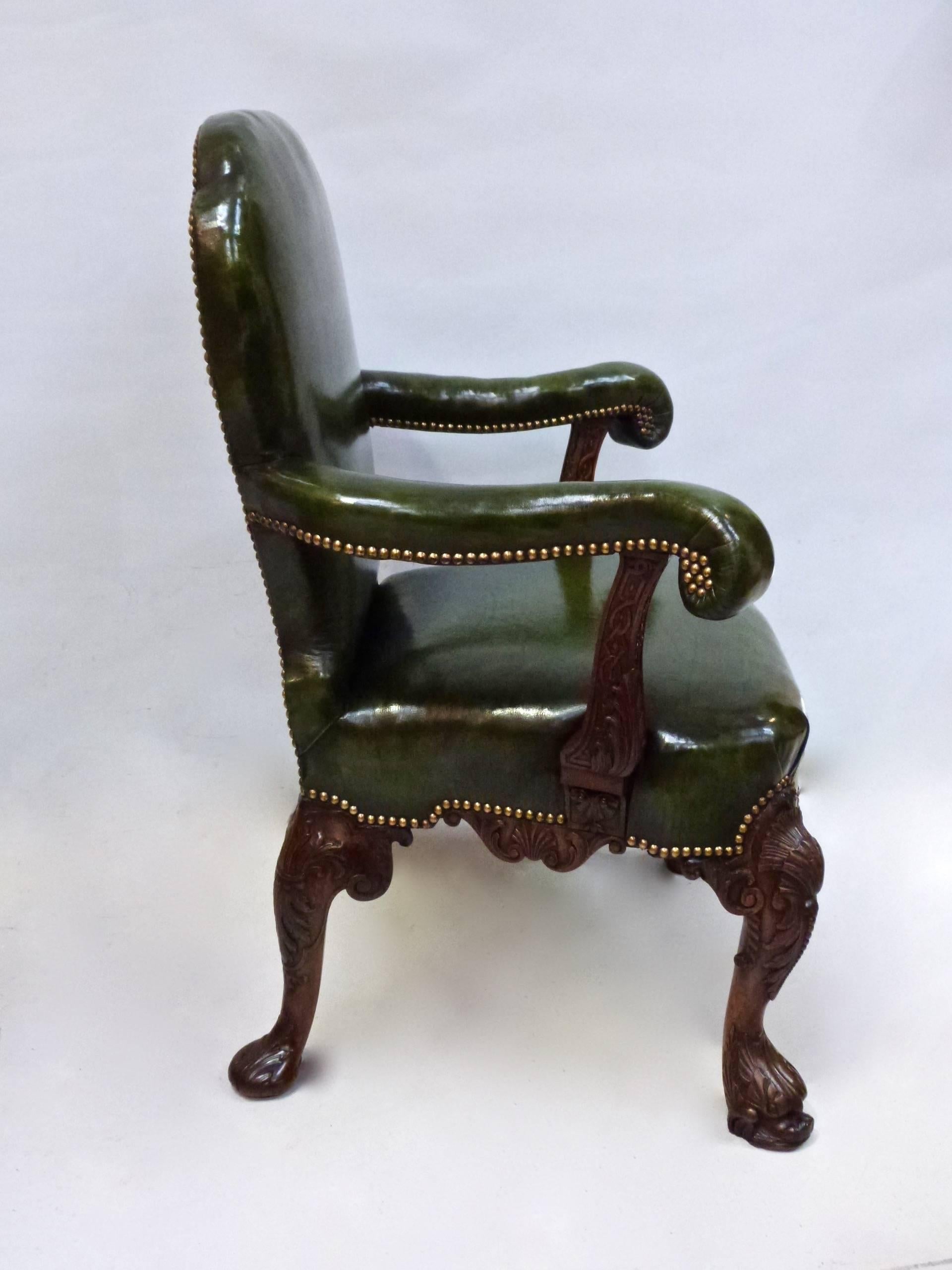 A superb quality George II style carved walnut library chair, circa 1850. (The trade label for London cabinet makers Landall and Gordon possibly a later addition.) Green leather upholstery also later.
A similar lady's chair is also available.