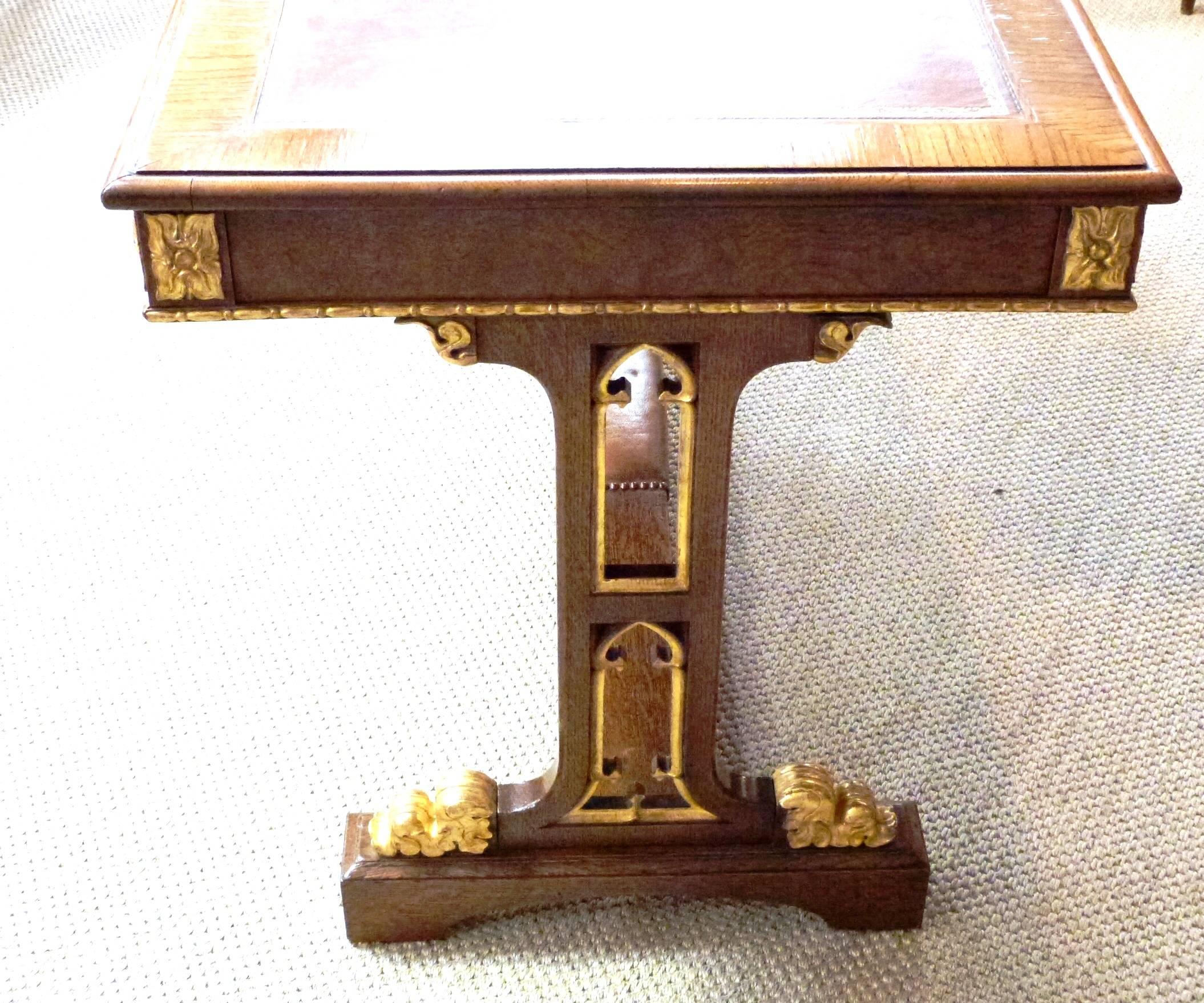 A good quality William IV oak and parcel-gilt Gothic style writing table.