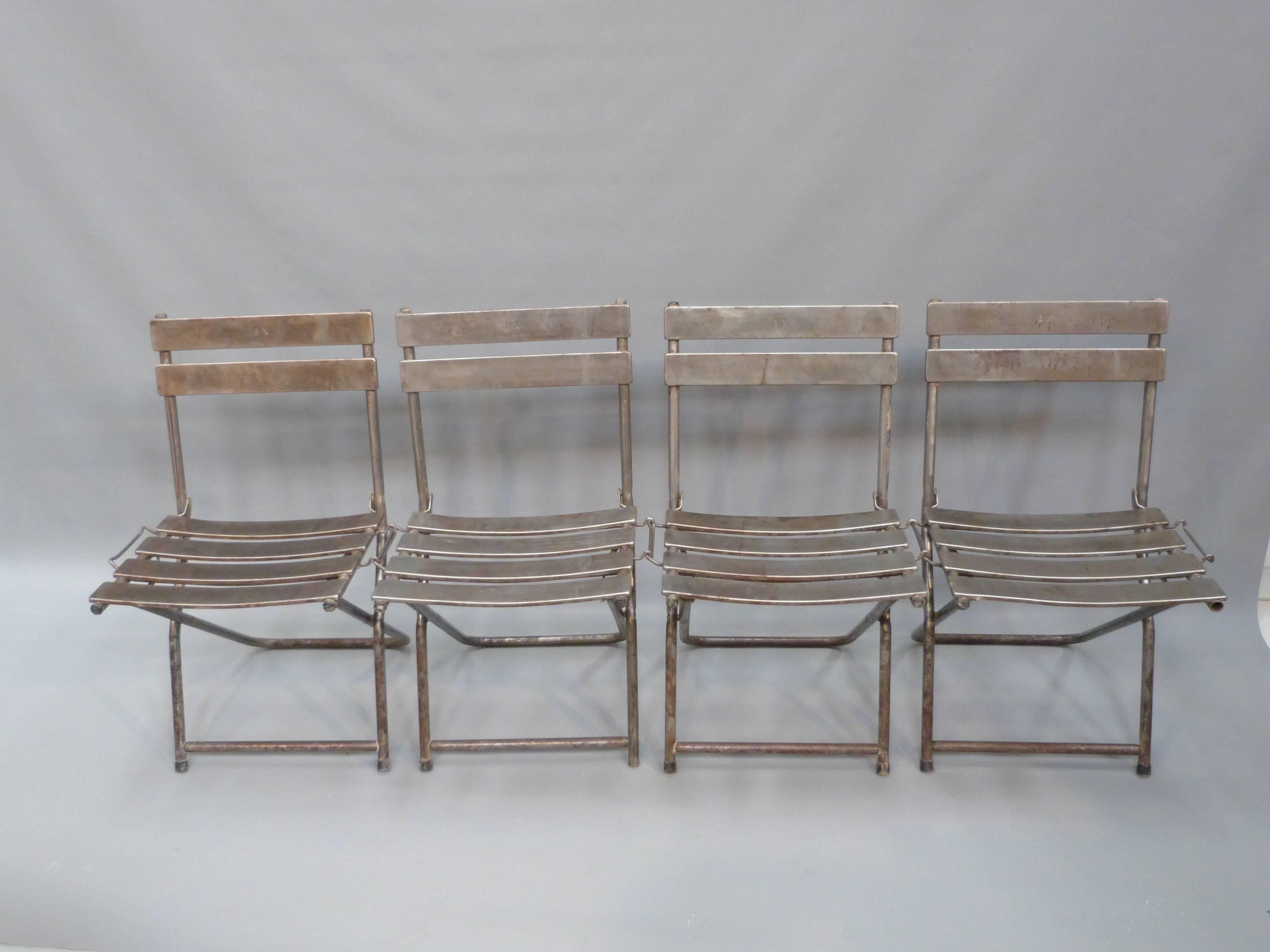 Set of eight French folding steel chairs, circa 1940.