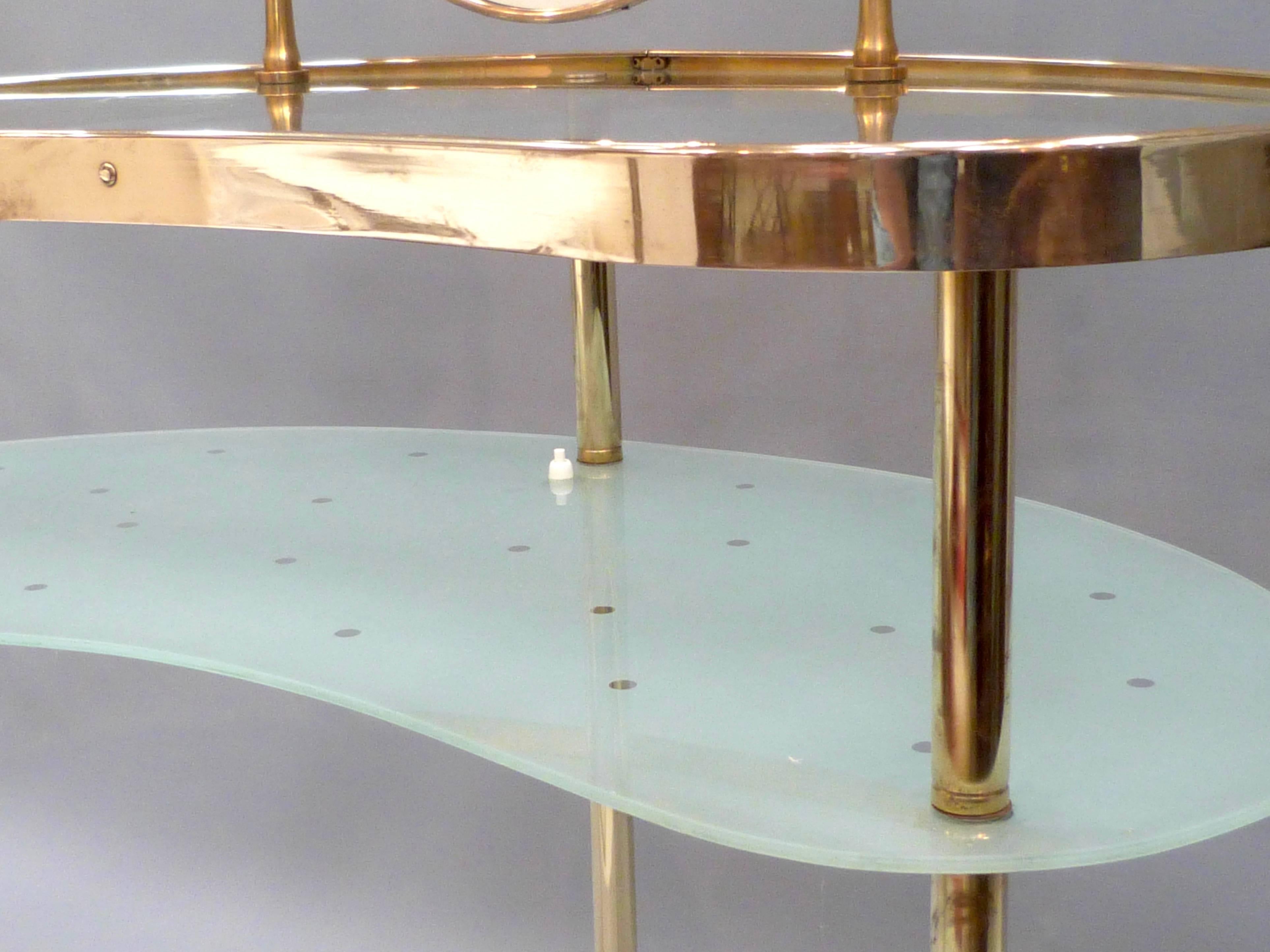 An unusual mid-20th century Italian brass and glass dressing table with integral brass framed mirror.
