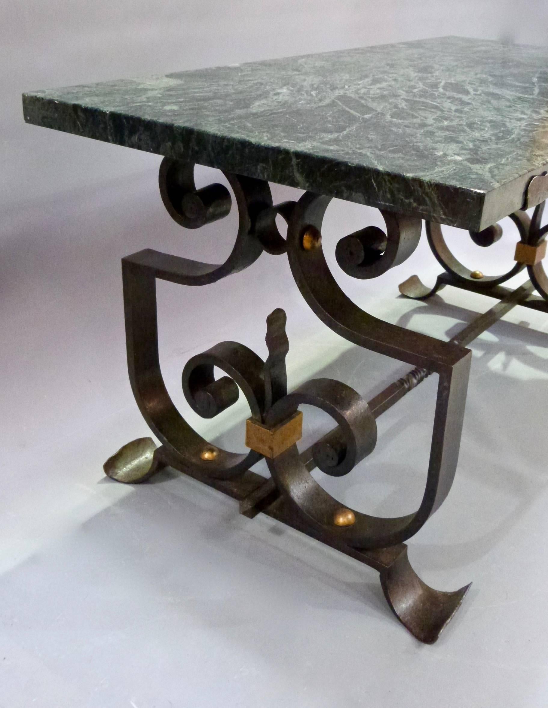 A very good quality wrought iron and marble low coffee table attributed to Marcel Bergue.