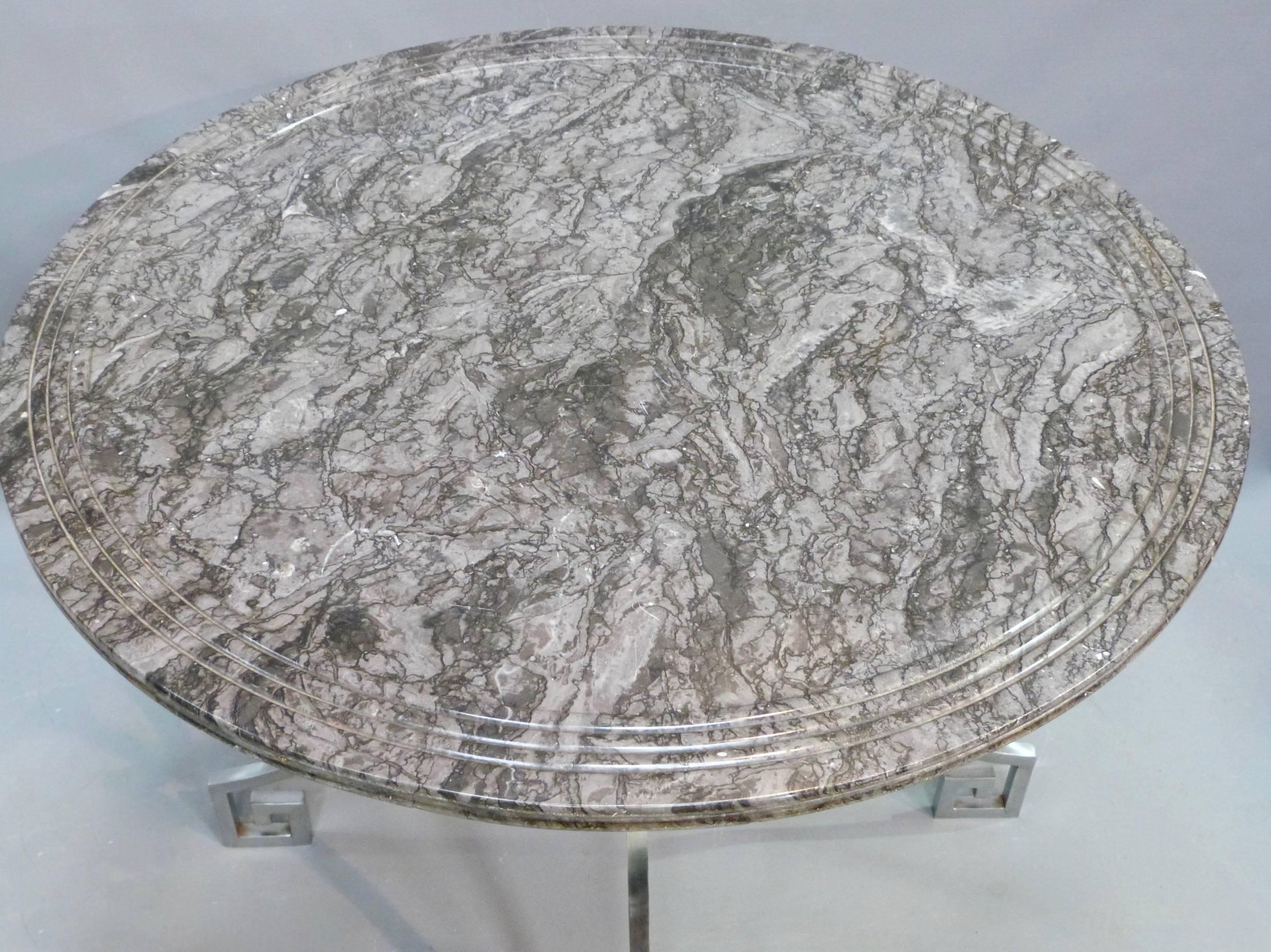 A superb quality mid-20th century nickel-plated centre table. The associated 19th century marble top sits on four curved nickel-plated legs which are joined by a brass ring and are finished on wonderful Greek key feet.