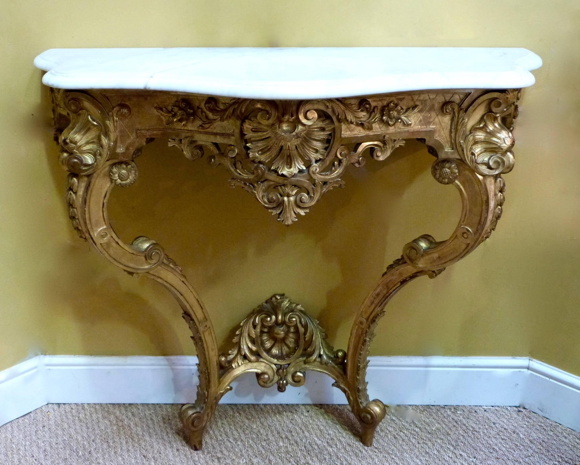 A fine quality late 19th century French carved giltwood Rococo style matching mirror and console table.