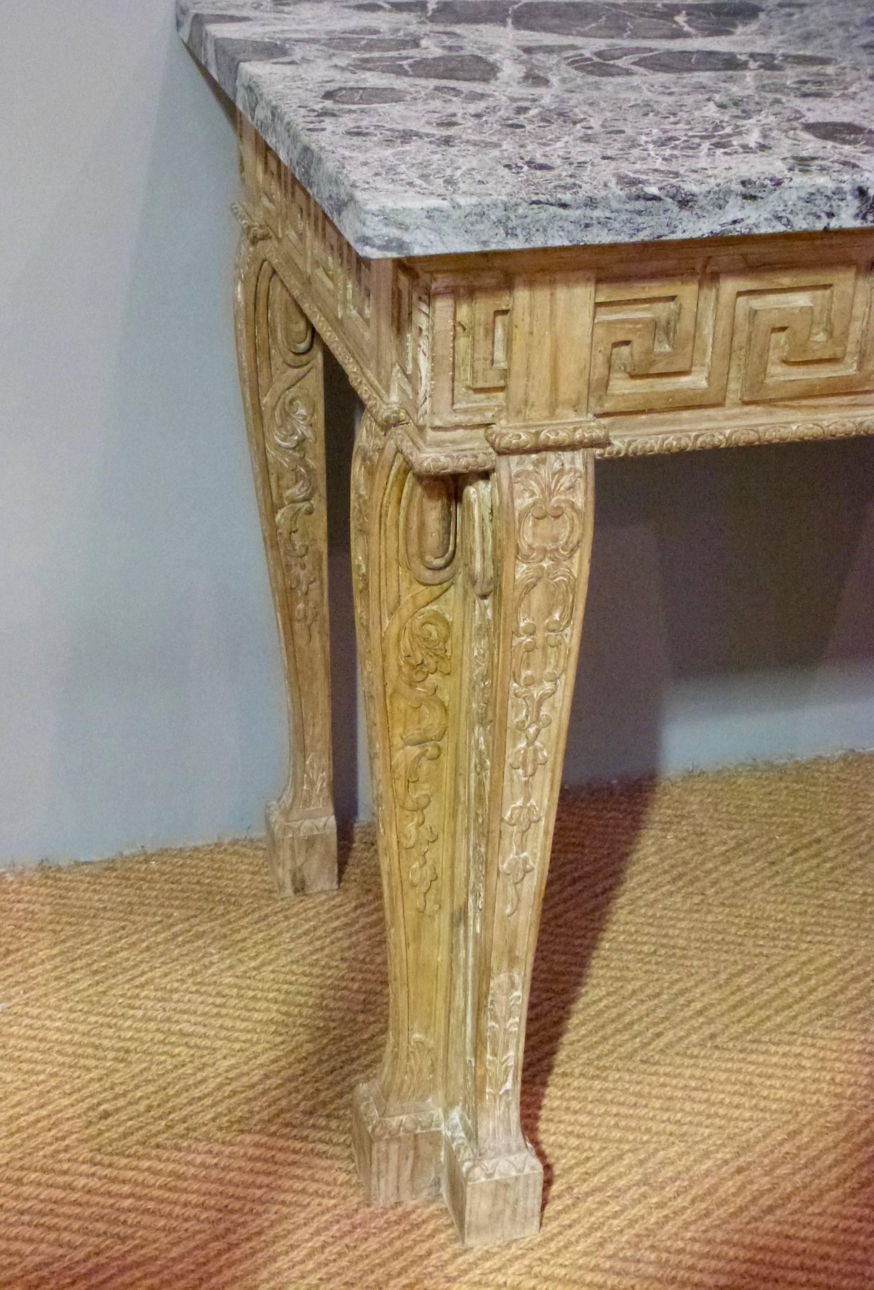 A Pair of early 20th century carved pine console tables in the style of William Kent with later marble tops, circa 1920.
