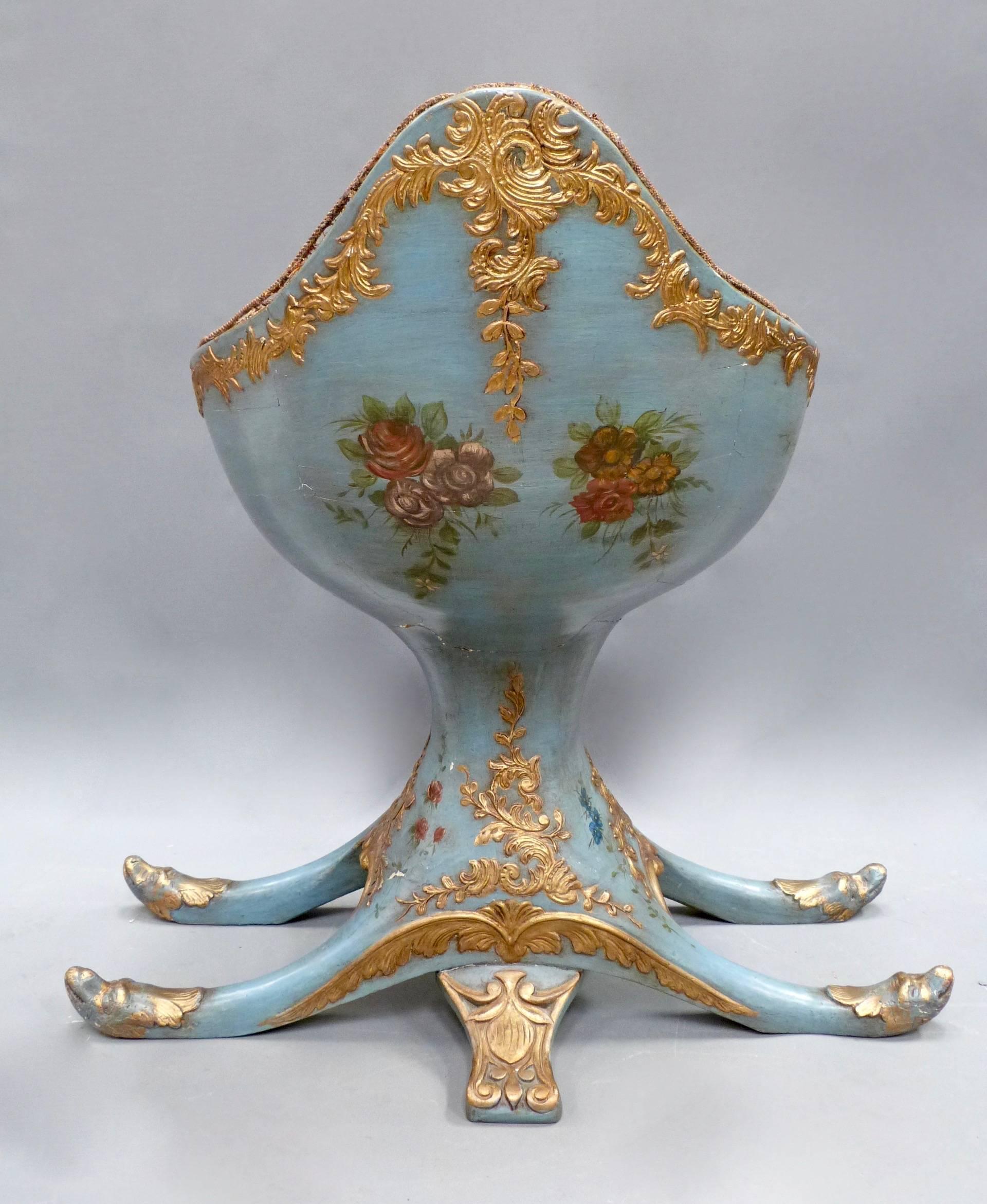 An early 20th century Italian painted and gilt Gondola chair. The chair features all-over paint work in Blue with painted floral decoration and a painted panel of the The St Mark Lion.