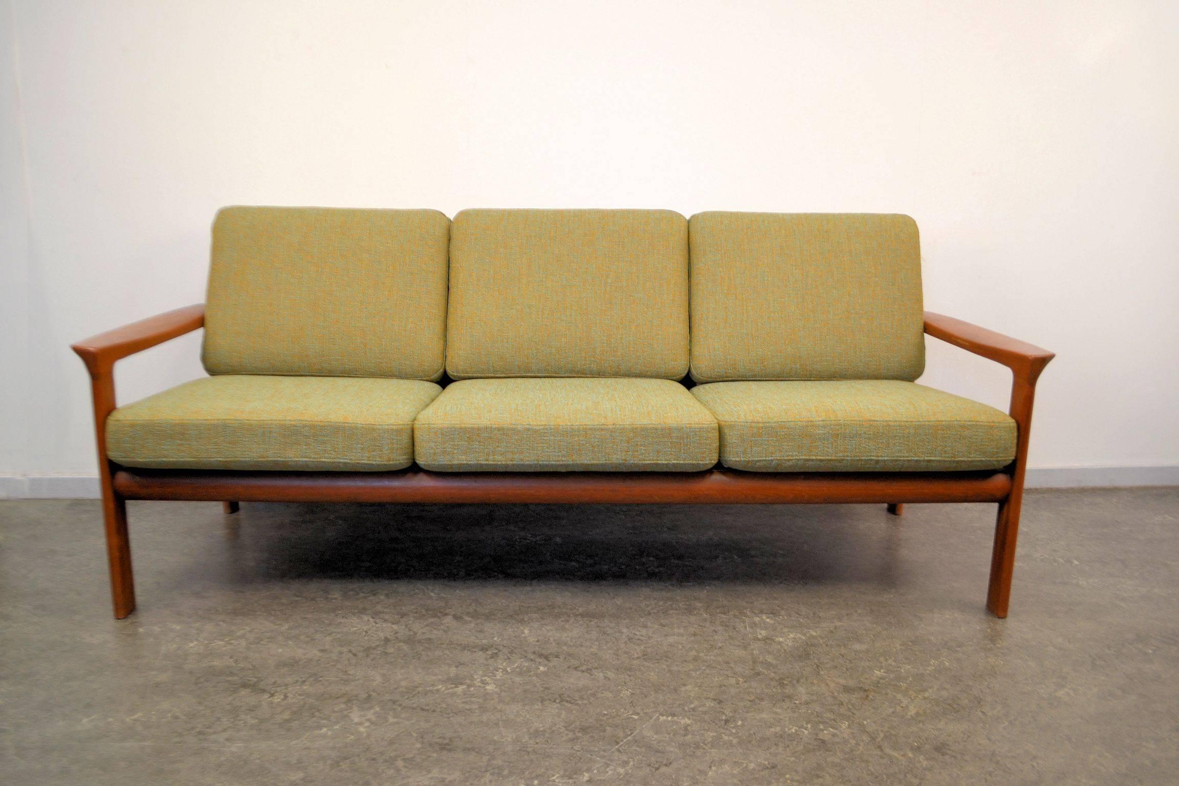 Stylish Danish modern sofa designed in the 1960s by Sven Ellekaer for manufacturer Komfort. Featuring characteristic Danish modern design and quality, a solid teak frame and new easy to remove upholstery. Create a stunning vintage with the available