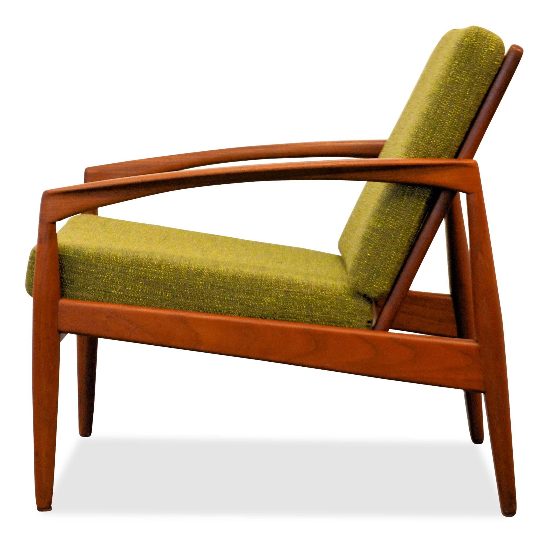 Super stylish Danish Modern Kai Kristiansen model 121 lounge chair. This iconic chair is otherwise known as the ‘paper knife’ chair, named after its slender curved armrests. Made out of solid teak wood, featuring clean lines and amazing details this