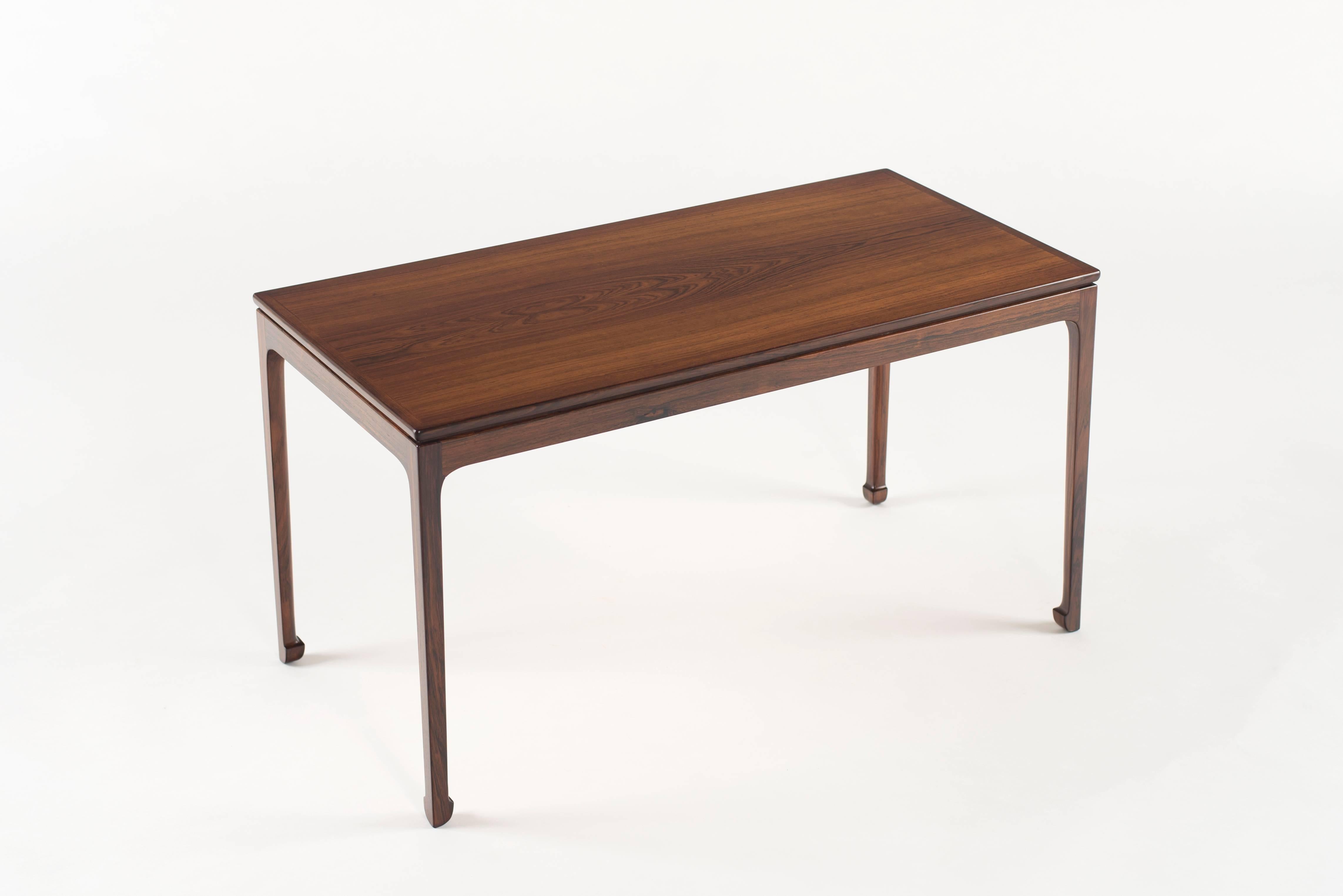 Coffee table in rosewood by Ole Wanscher, 1956. 

Executed by cabinetmaker A.J. Iversen, Copenhagen, Denmark.