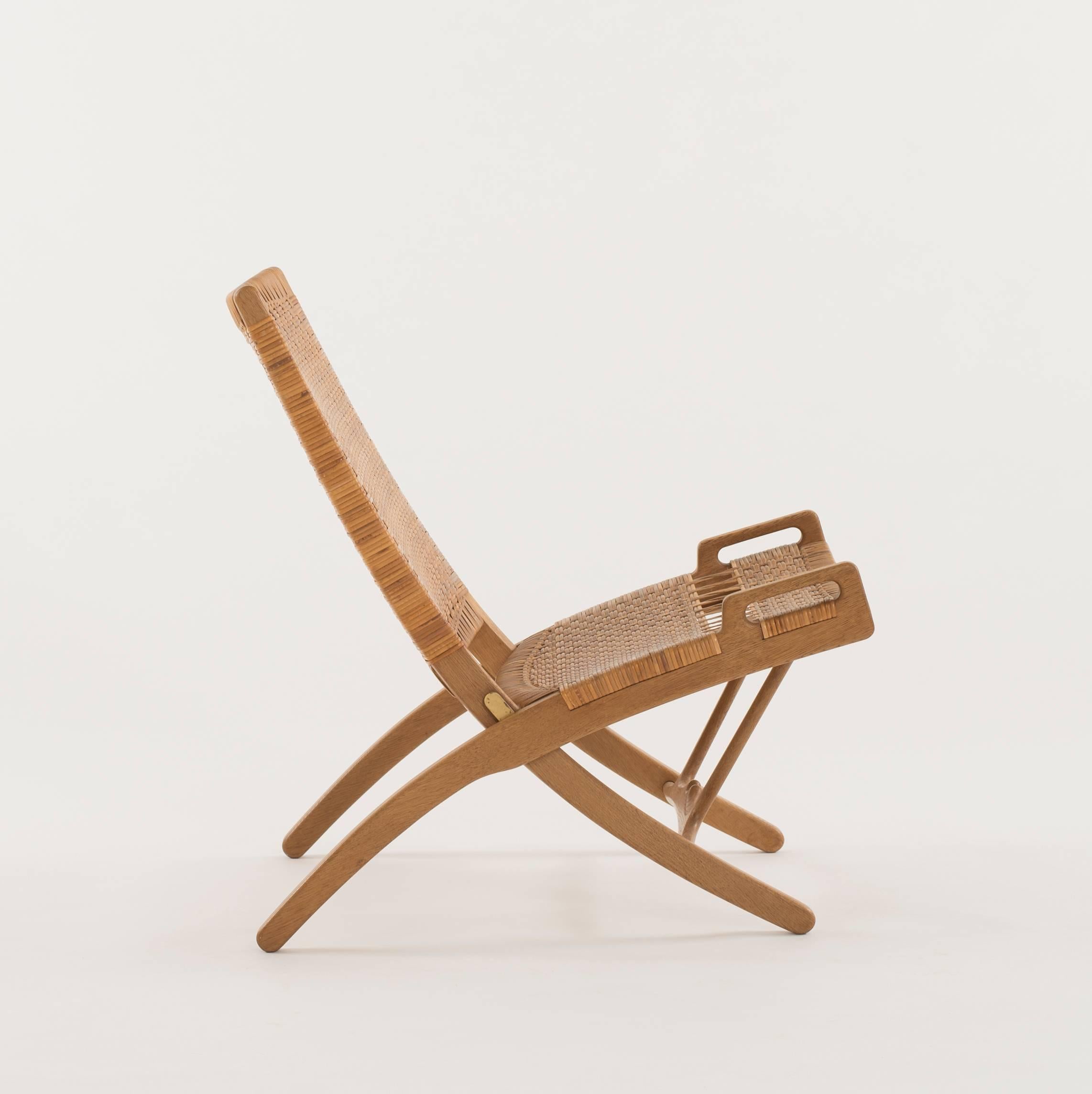 Hans J. Wegner folding chair of oak model JH-512, 1949. Executed by Johannes Hansen, Copenhagen, Denmark. 