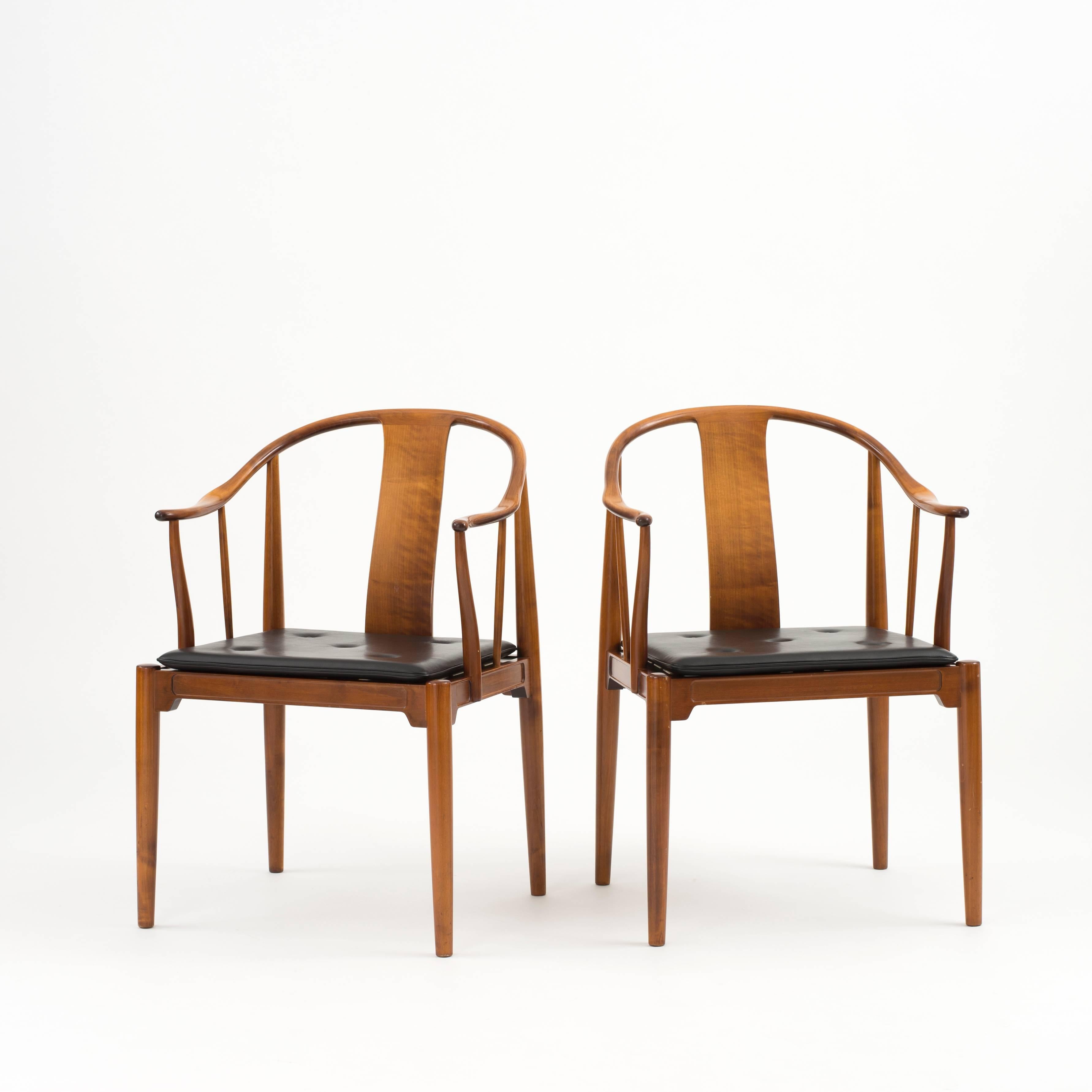 A pair of Hans J. Wegner 'China Chair', 1944. Executed by Fritz Hansen, Denmark, 1972. 

Stained cherrywood and leather cushions. 

 