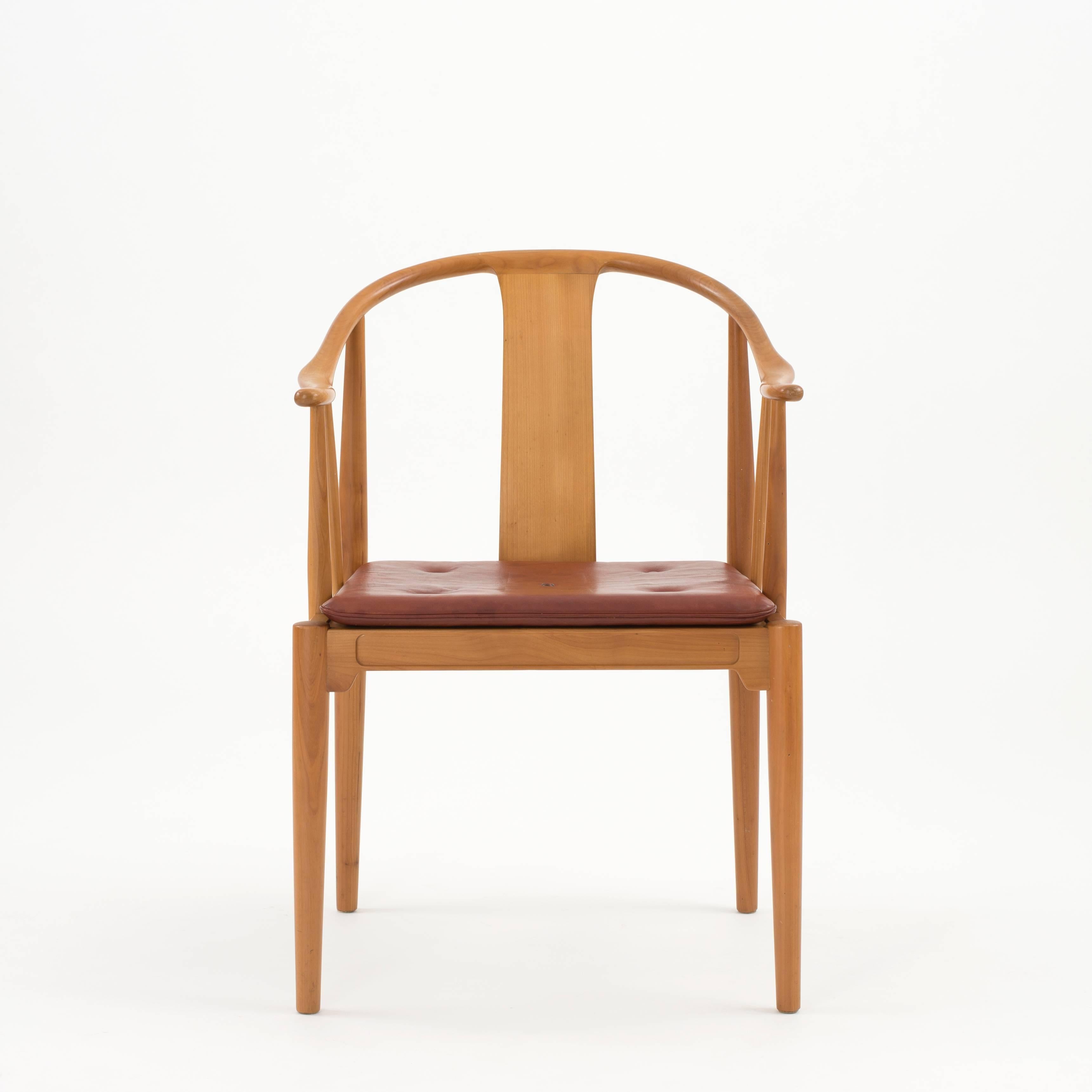 China chair by Hans J. Wegner, 1944. Executed by Fritz Hansen, 1970.

Cherry wood and natural tanned leather cushion.