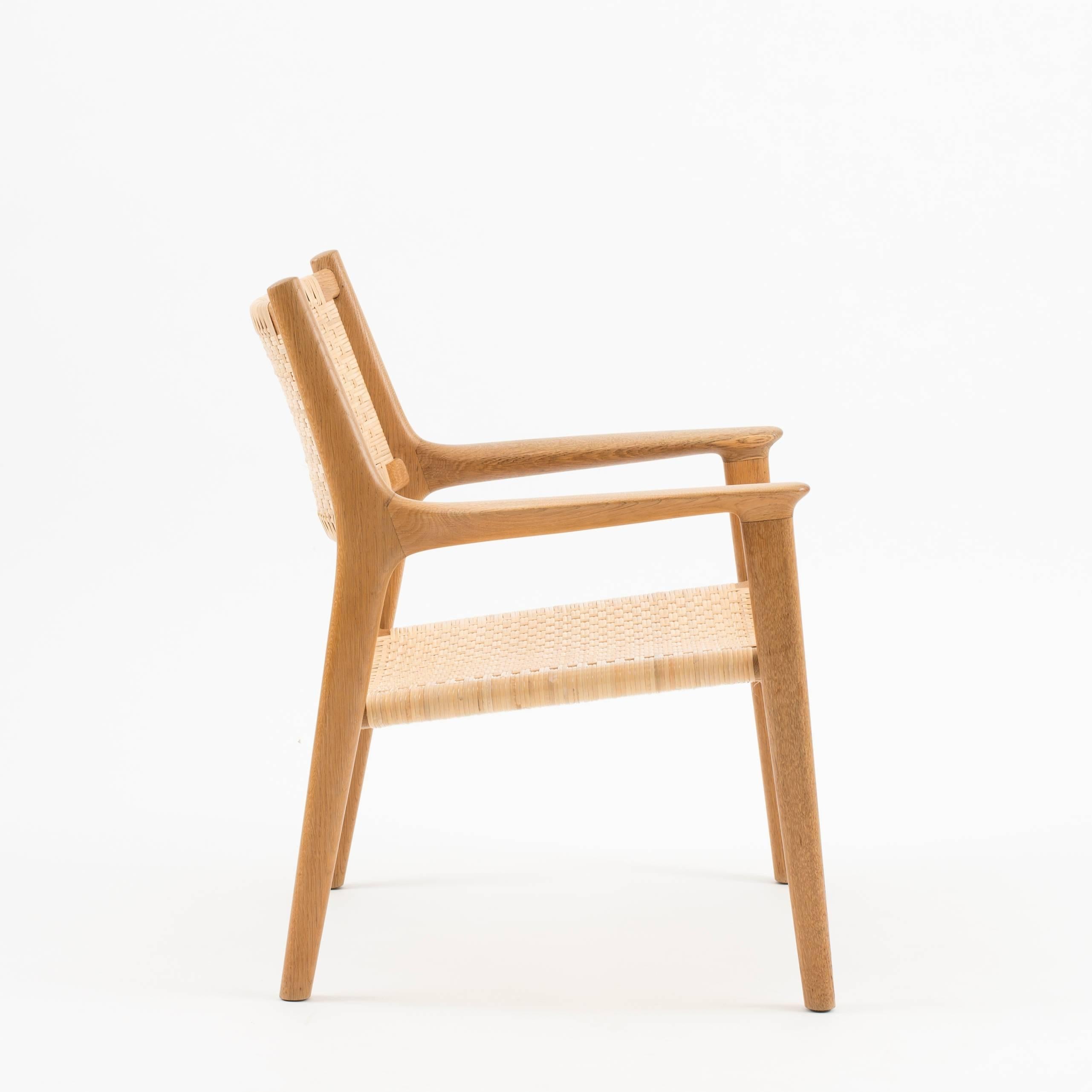 Hans J. Wegner Model JH-516 in oak and cane. Executed by Johannes Hansen, Copenhagen, Denmark.