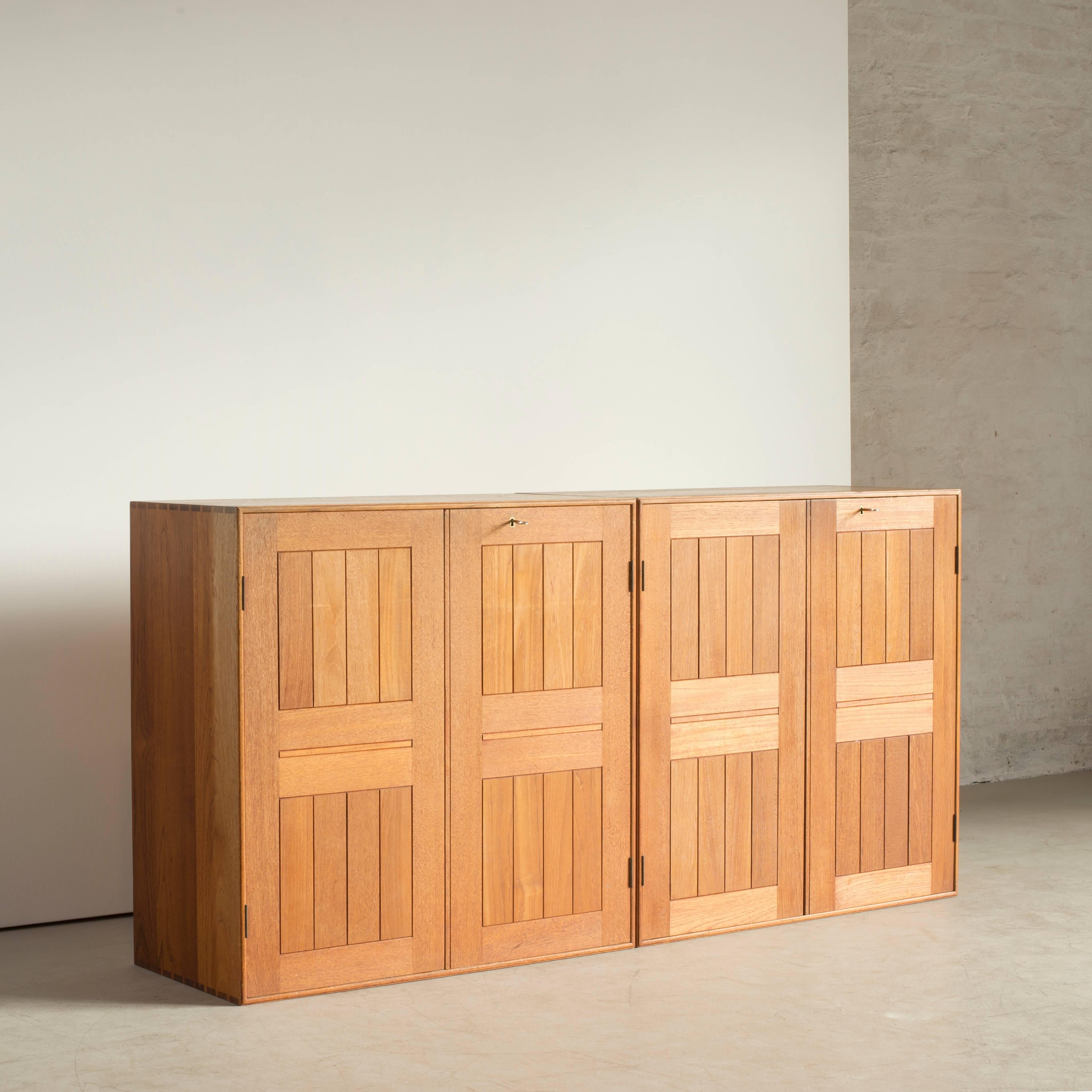 A pair of Mogens Koch cabinets in treak. Removable drawers in maple. Executed by Rud. Rasmussen.

Reverse with manufacturer's paper label RUD. RASMUSSEN / SNEDKERIER / 45 NØRREBROGADE / KØBENHAVN.