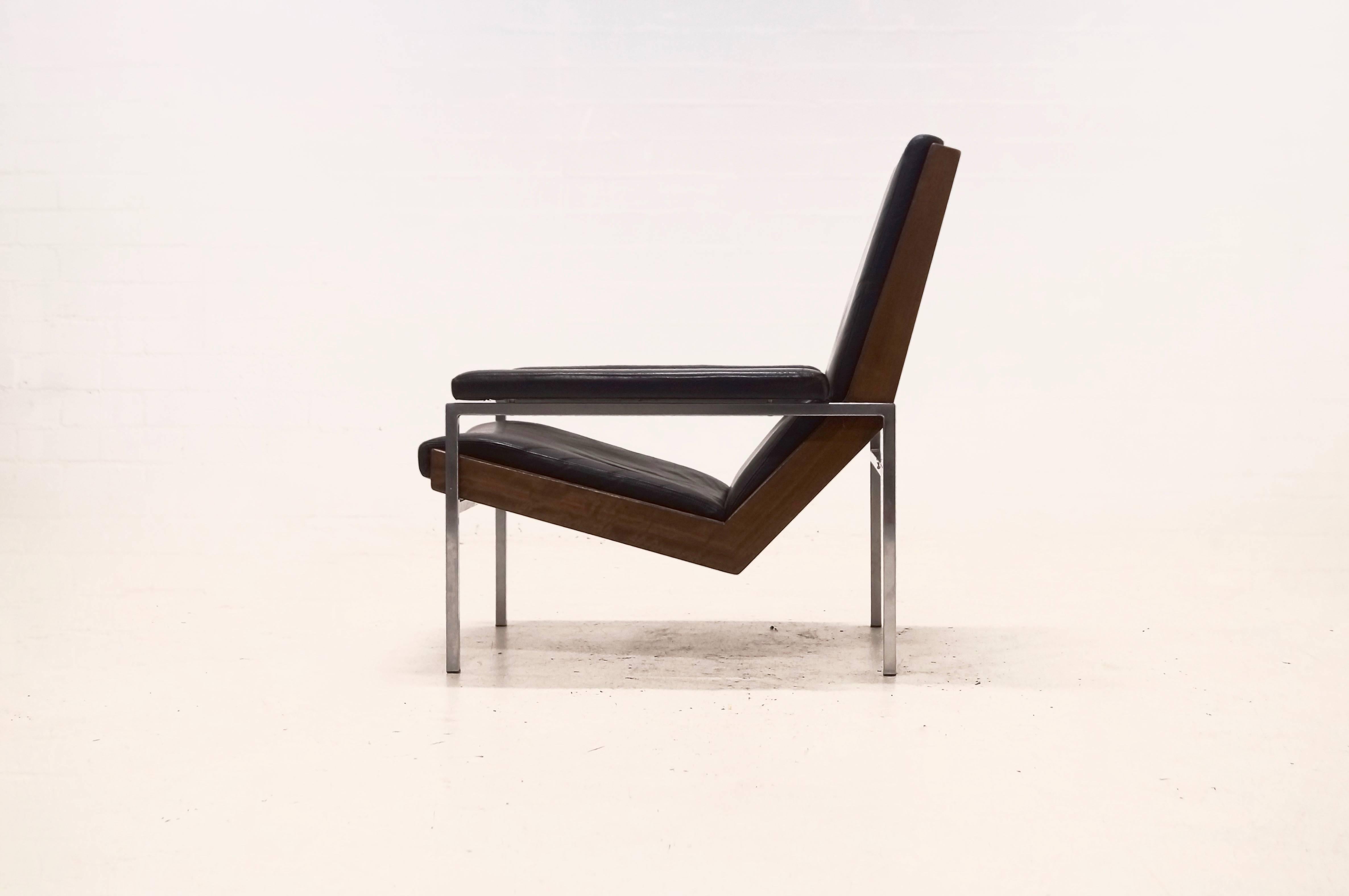 Mid-Century 'Lotus' lounge chair designed by Rob Parry and produced by Gelderland Holland. The chair has a chromed metal frame combined with teak and is upholstered with beautiful black leather. The leather on one of the armrests has some patina as