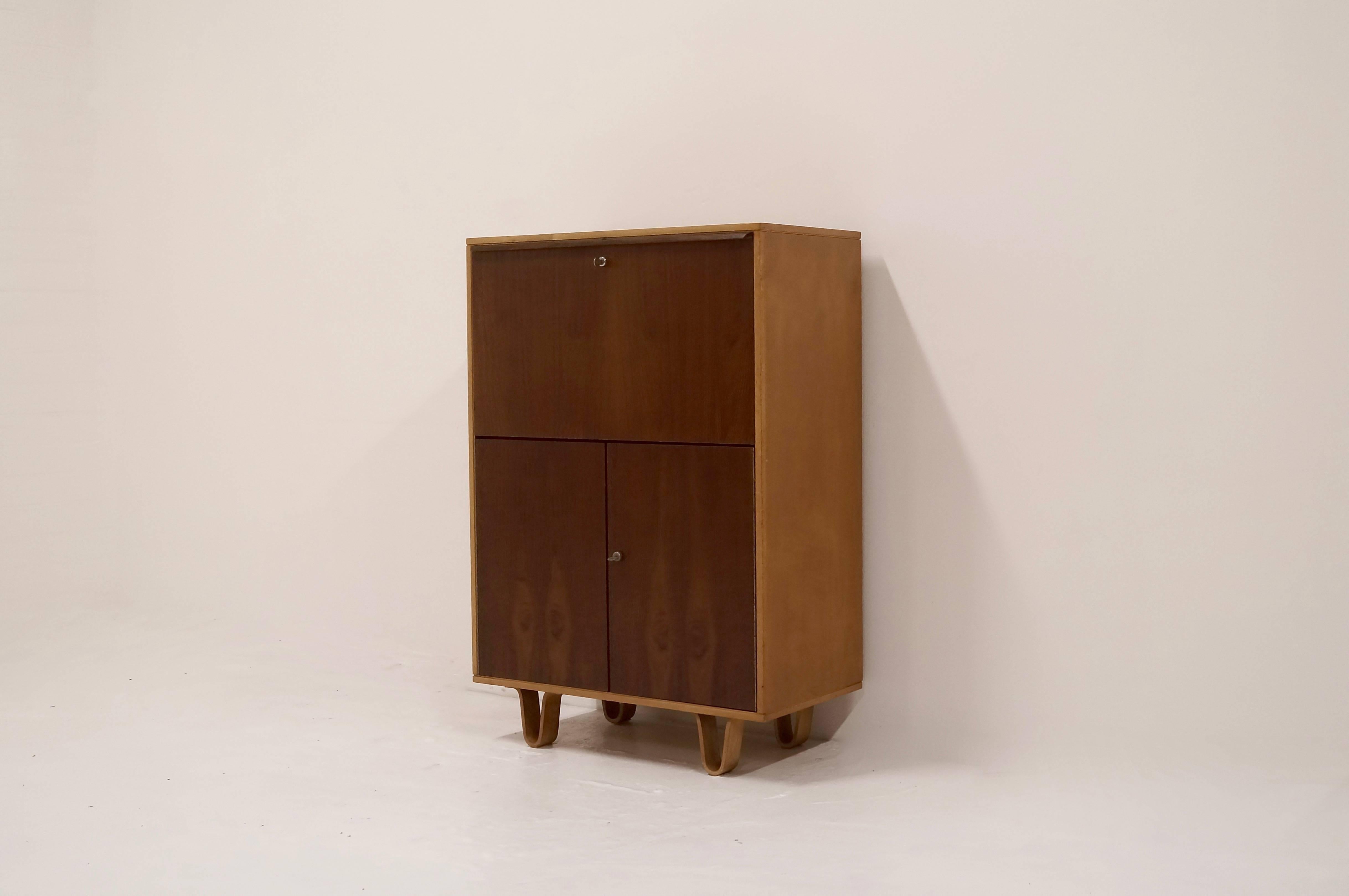 UMS Pastoe CB07 writing desk cabinet designed by Cees Braakman for Pastoe UMS Utrecht, Holland, 1950s. The cabinet is from the infamous birch series and has distinctive bended plywood legs. Both the door panels as well as the desk top are made of