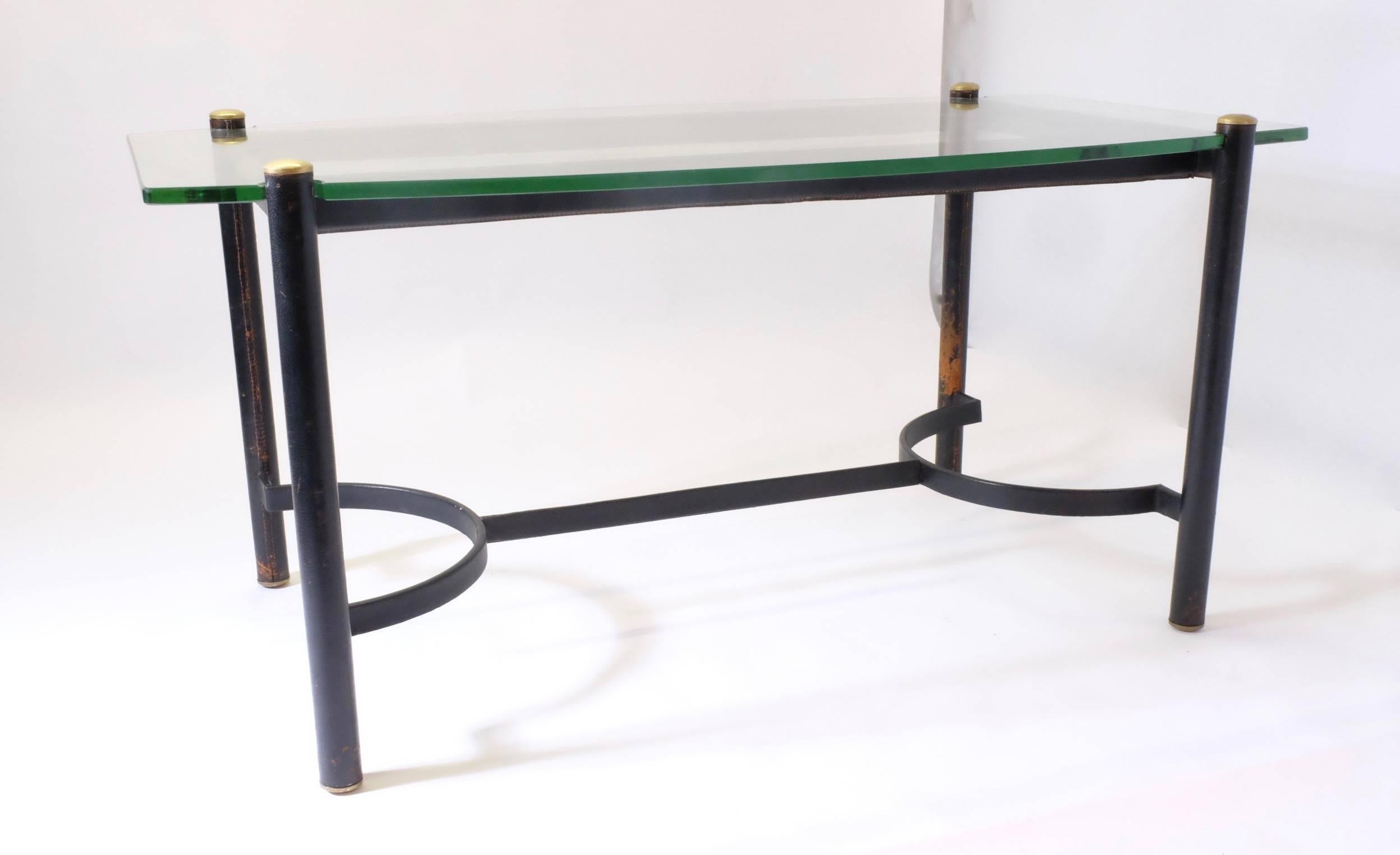 A rare and original desk or dining table by Jacques Adnet in very good condition, circa 1960. Original top on glass.