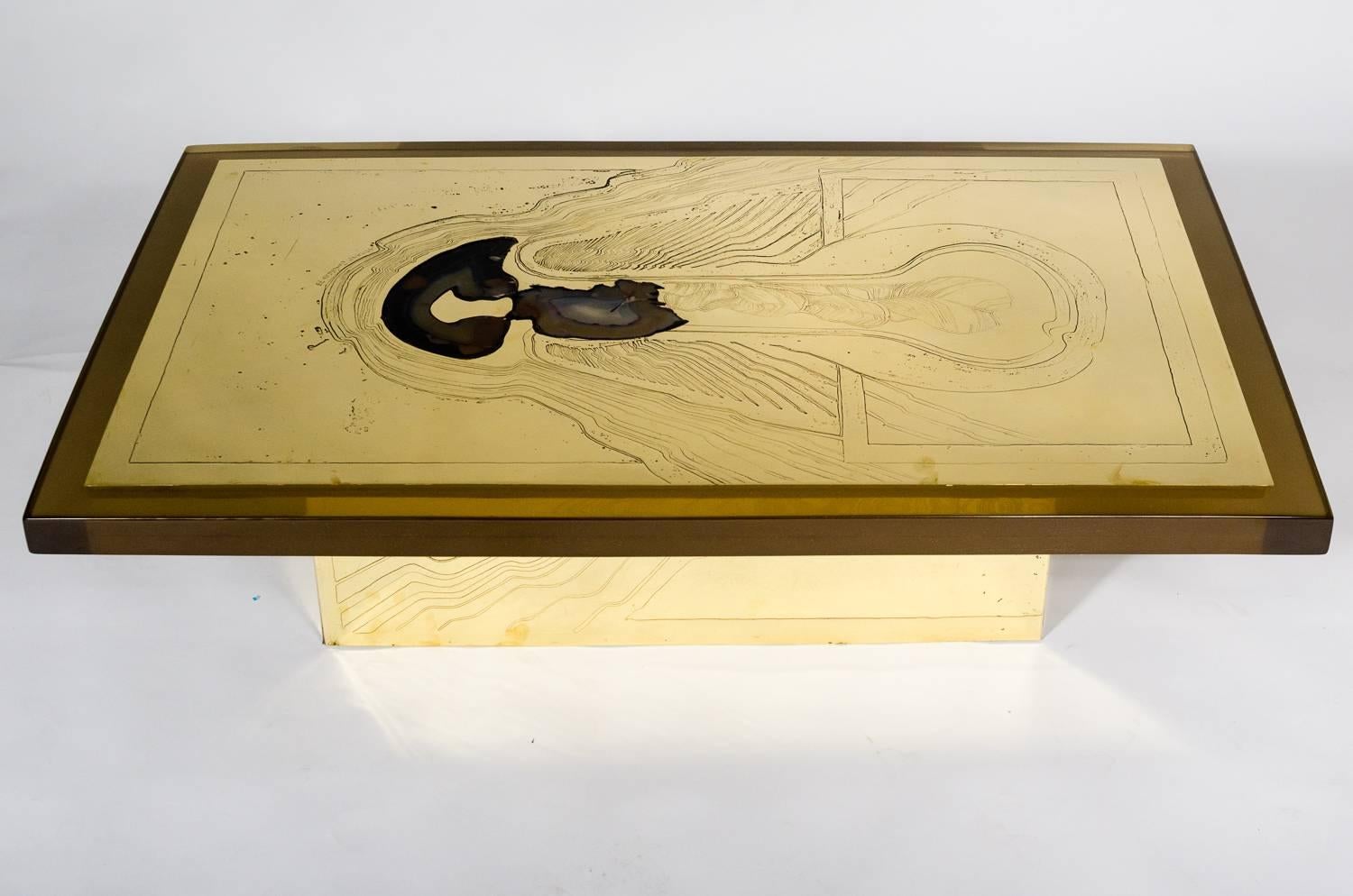 Engraved etched brass coffee table designed by Armand Jonckers in 1973, with a resin surrounding an agate stone top. The table Stand is also etched with acid representing deep sea waves the table is lighted from the inside. This furniture has been