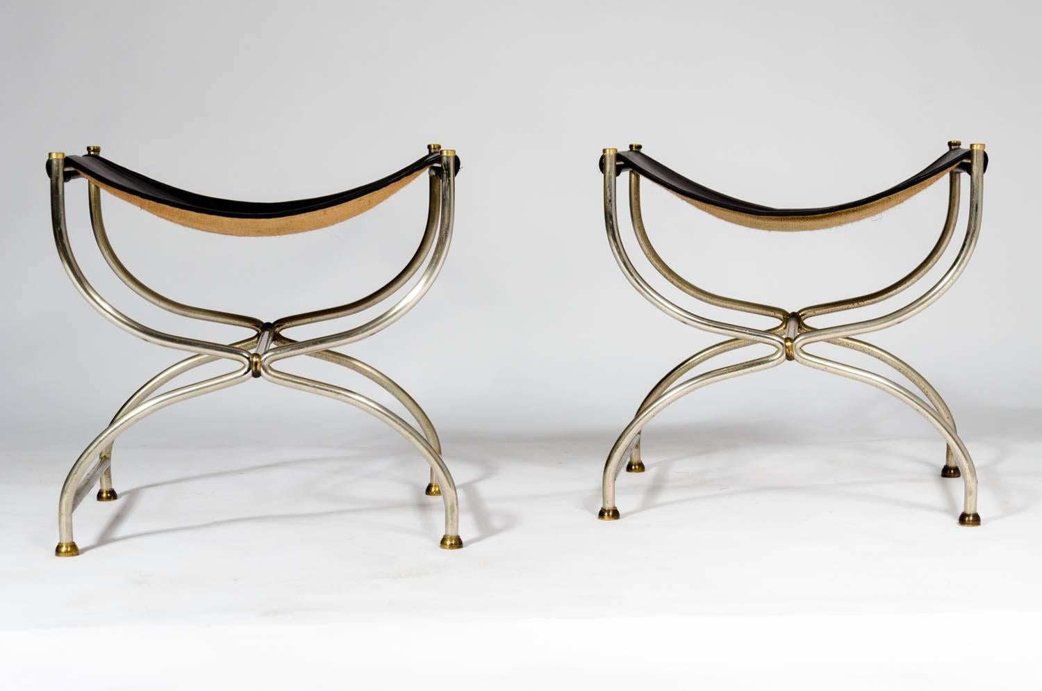 A pair of stool designed by Jansen work shop and manufactured in stainless steel, solid brass and black leather. The furniture is in its original state. We have two set of pairs available, circa 1960.