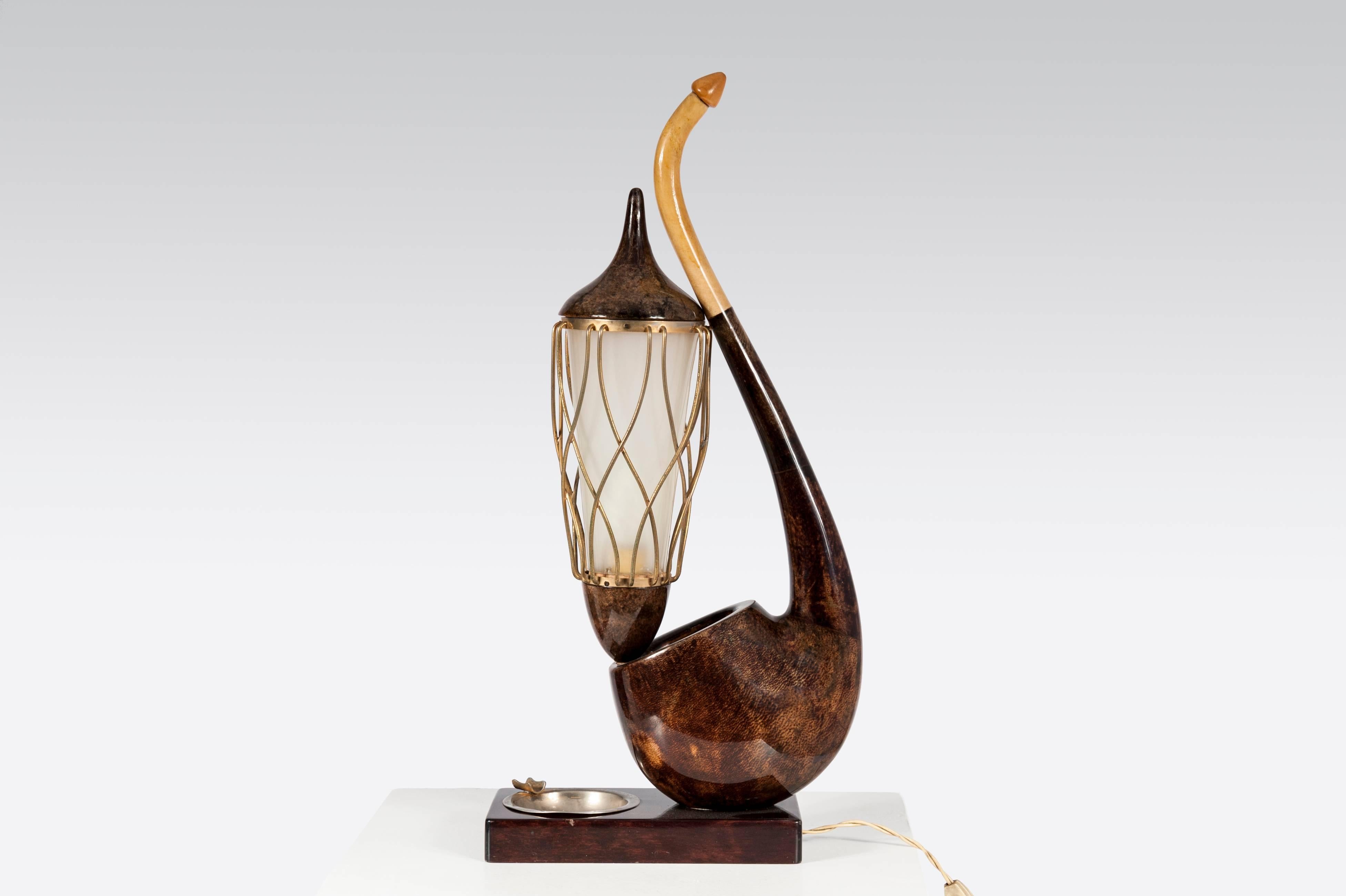 This table lamp was designed in by Aldo Tura and was produced in Milan, circa 1960. It is made from brown lacquered with the handle and cage in gilt brass. The lampshade is made from plastic and it's in original and very good vintage condition.