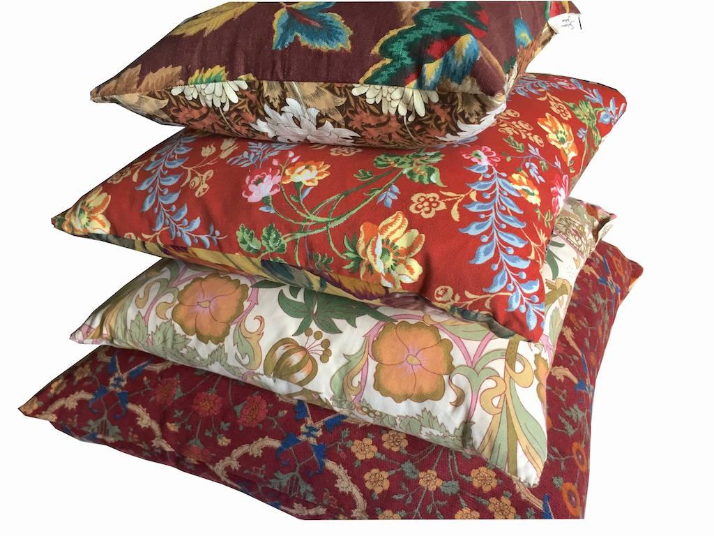 A one-off cushion collection in heritage fabrics, a maximalist combination of earth hue with bright red and orange accents; heritage textiles in Sanderson screenprinted cotton, Laura Ashley linen and Liberty of London floral cotton. Curated and made