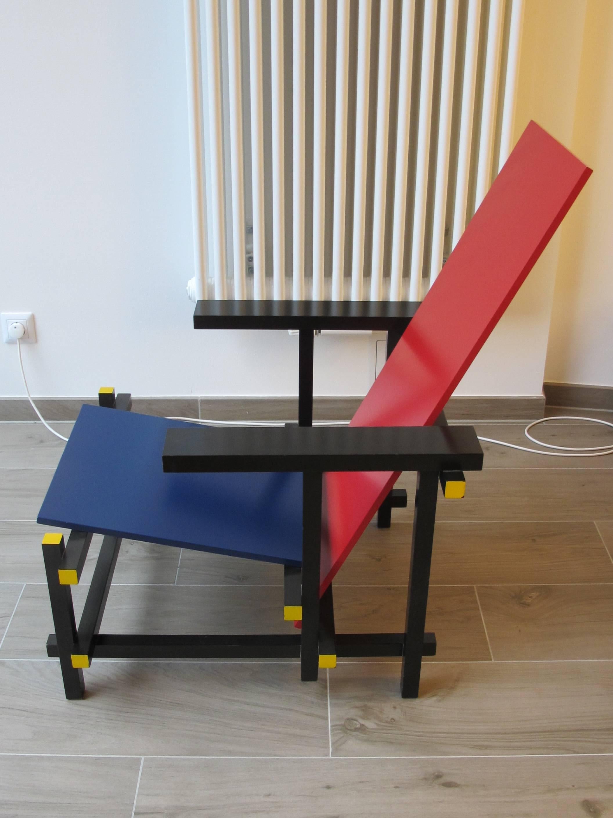 Lounge chair with frame in black stained beech. Seat (blue) and back (red) in lacquered multiplywood.

With its subtle play of horizontal and vertical lines this neoplastic chair became a manifesto for the De Stijl, so that all the parts for its