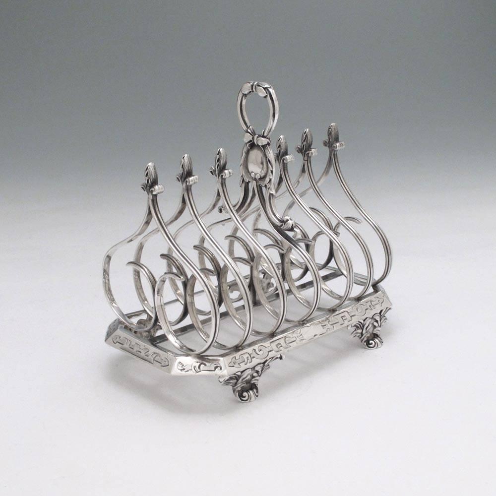 London, 1835/44 by Charles T. & George Fox.

It is unusual to find a toast-rack that shows a little style, so we were pleased to find this Gothic/Renaissance example.