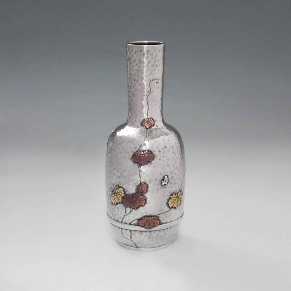 A lovely small vase by Tiffany, with a nice array of bugs and leaves in the mixed-metals Japonisme taste.

An example of the so-called Japonisme style pioneered by Tiffany in the late 1870s and debuted at the Paris Exposition in 1878, this piece