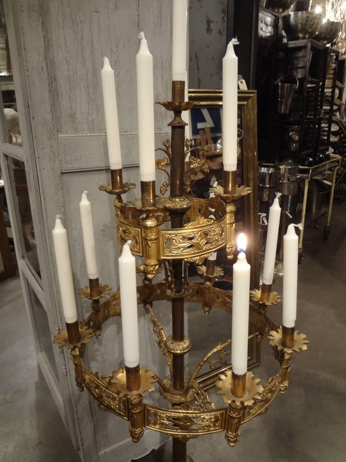 Beautiful and highly decorative antique candelabra, from a church in Southern France. In aged gilt bronze, and with 13 arms for candles. Eye-catching, whether in your private home, a restaurant or a shop!