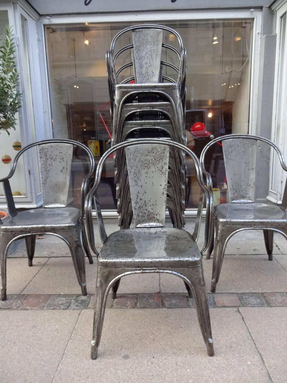 Fabulous vintage French metal Tolix chairs with armrests, designed by Xavier Pouchard. Produced since 1934, they are also displayed at New York’s MoMA and the Centre Pompidou in Paris. Appears in treated and polished iron. Super patina.