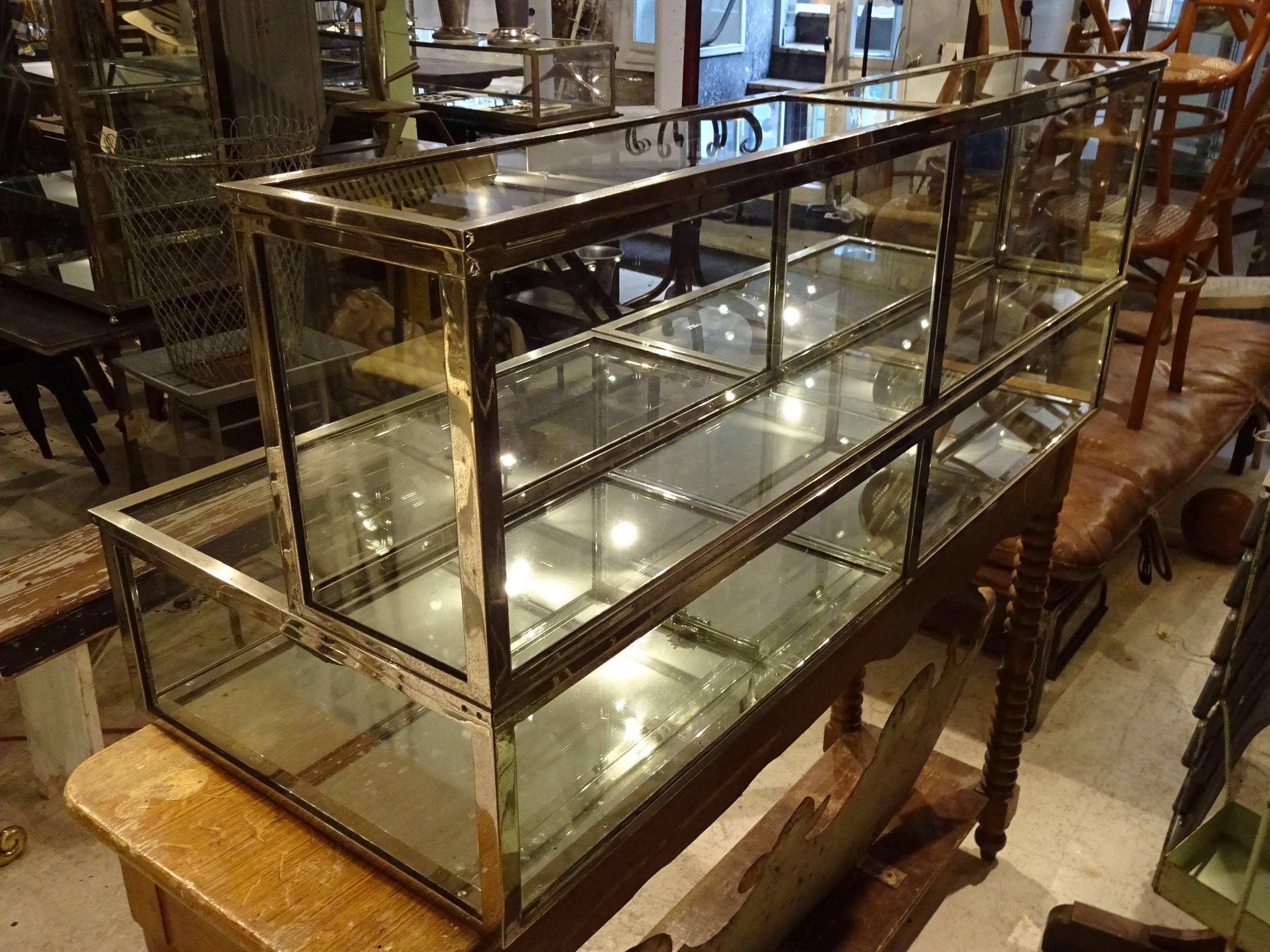 Elegant vintage table chrome and glass display case from the legendary firm Siegel in Paris, which for decades has made boutique equipment for the French market. This table display case is a special version, with double levels, and is divided into