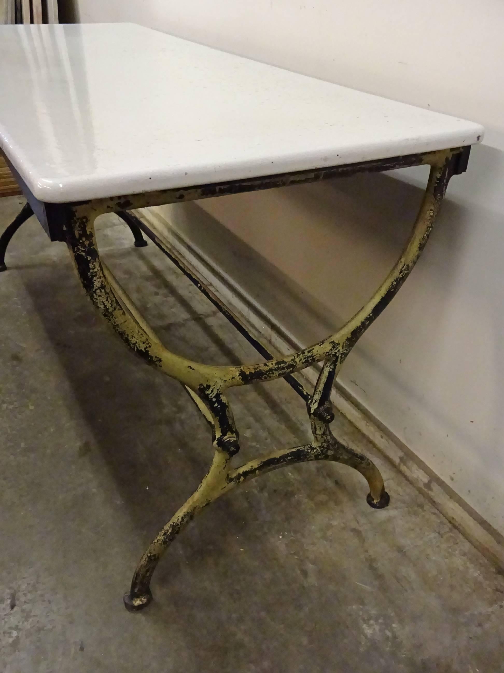 Fantastic and rare Industrial style painted cast iron refectory table / long table, with a beautiful white enamelled lava stone tabletop. Super elegant iron legs.

 