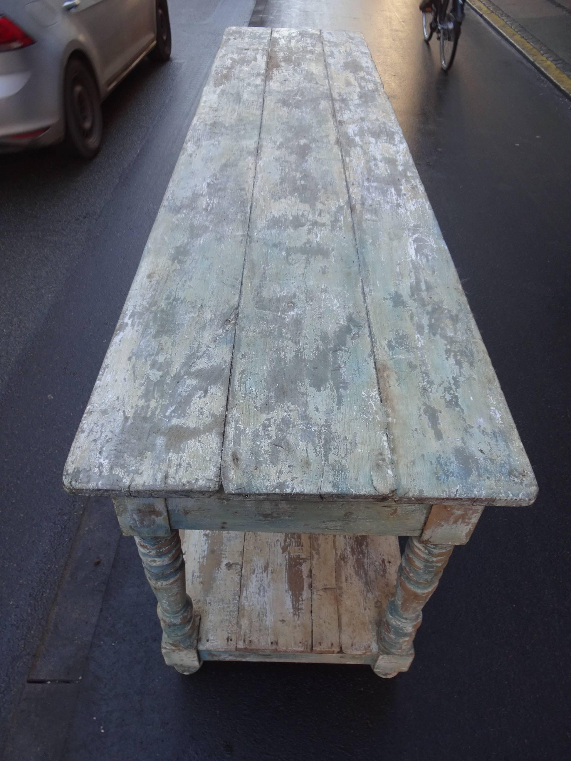 Wonderful vintage French console or drapier table with elongated lower shelf. Gorgeous patina with remains of the former colors the table has had through the times.
