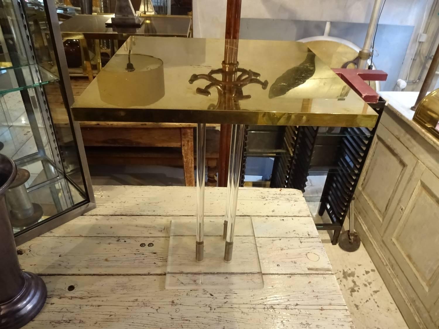 Cool 1960s-1970s square table with a shiny brass top and fine slim leg rods and plexiglass base. Fabulous as coffee table or lamp table.