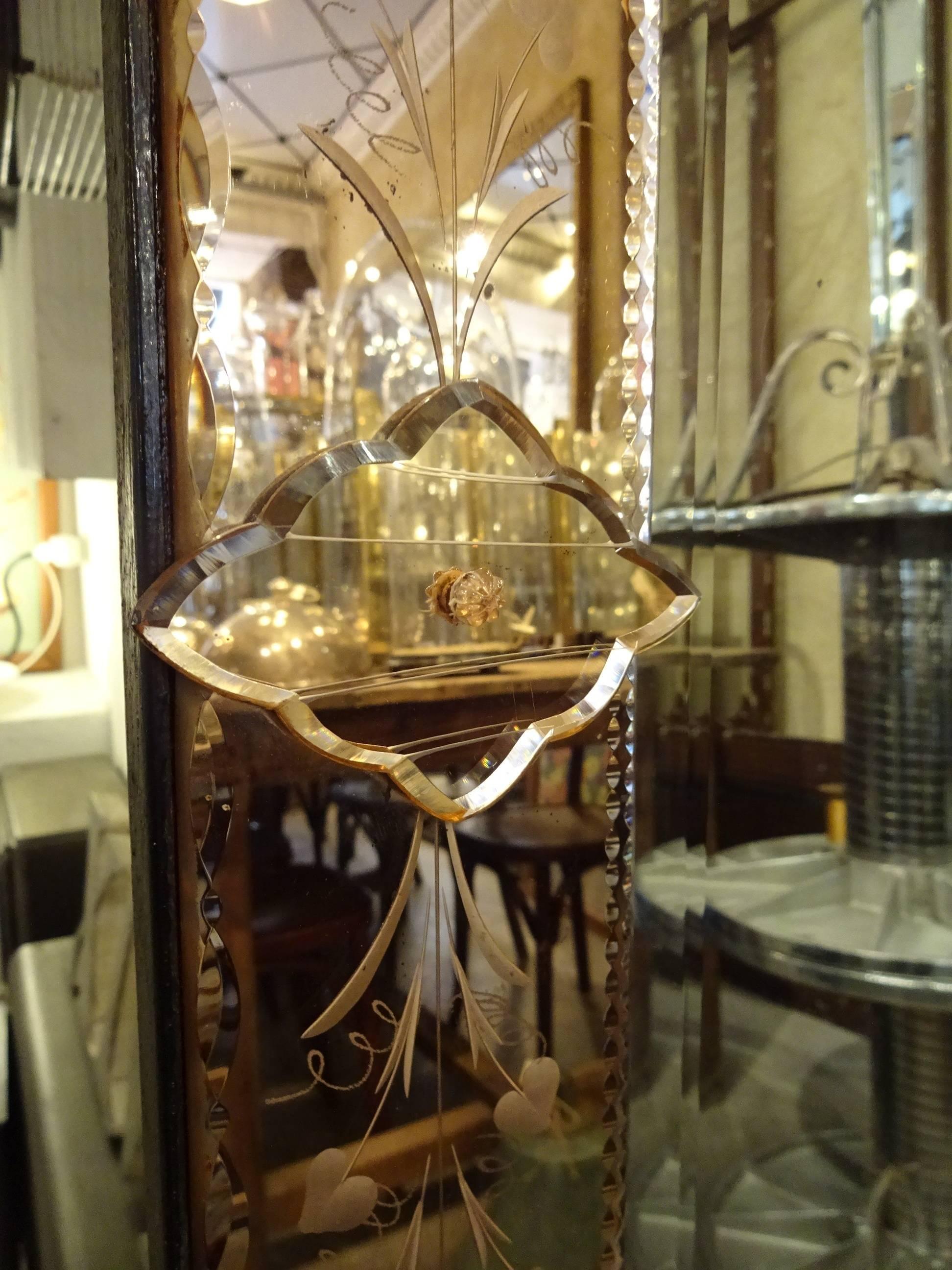 Fantastically stunning Venetian mirror, from circa 1920s-1940s, France. The opulent frame is in beautifully ornamental mirrored smoked glass.

A wonderful full length mirror, which would add to any room.