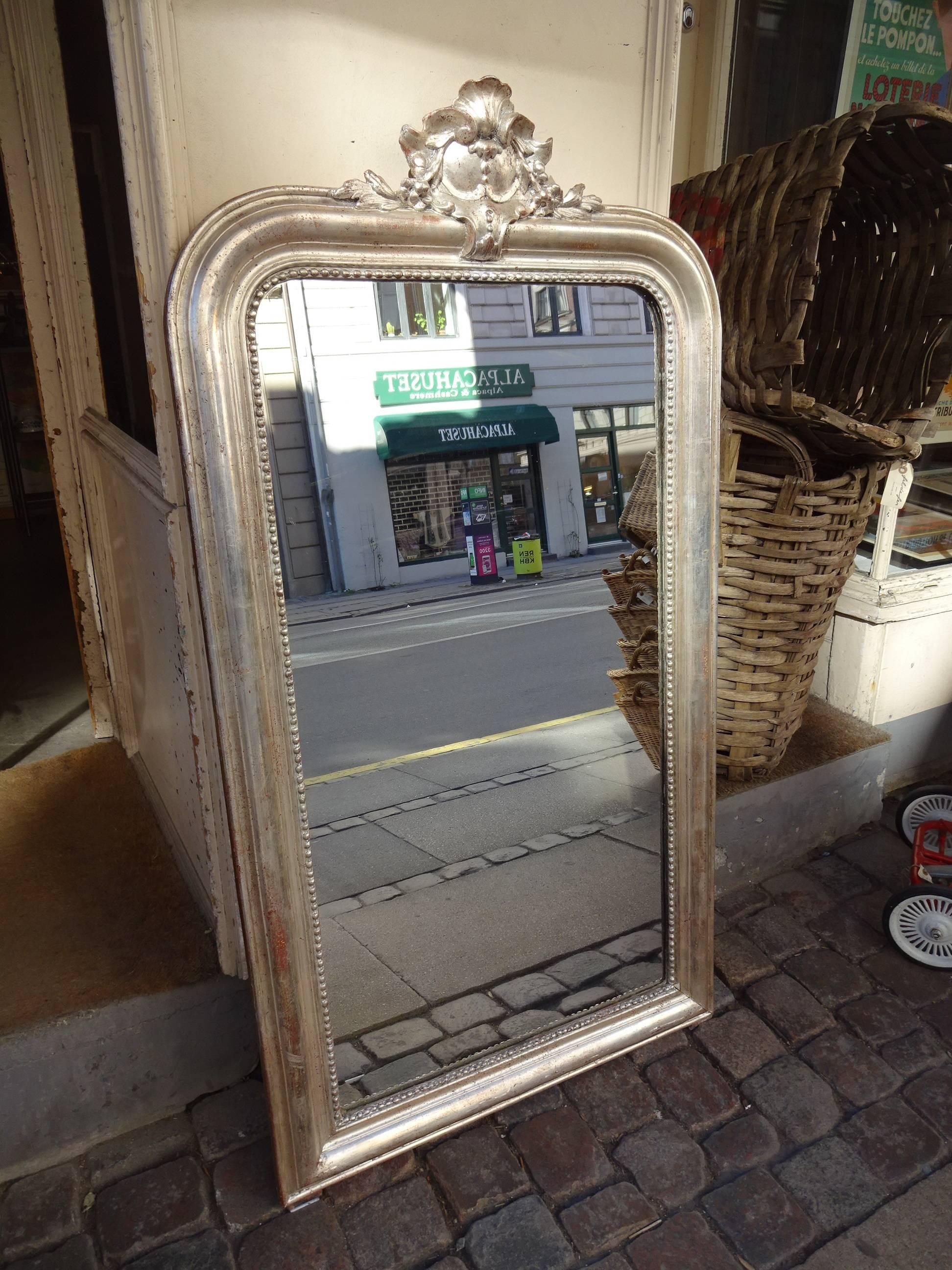 Antique Louis Philippe silver mirror from France. Original lovely silverleaf and patterning, as well as mirror glass. Wonderful ornate detail at the top of the frame.