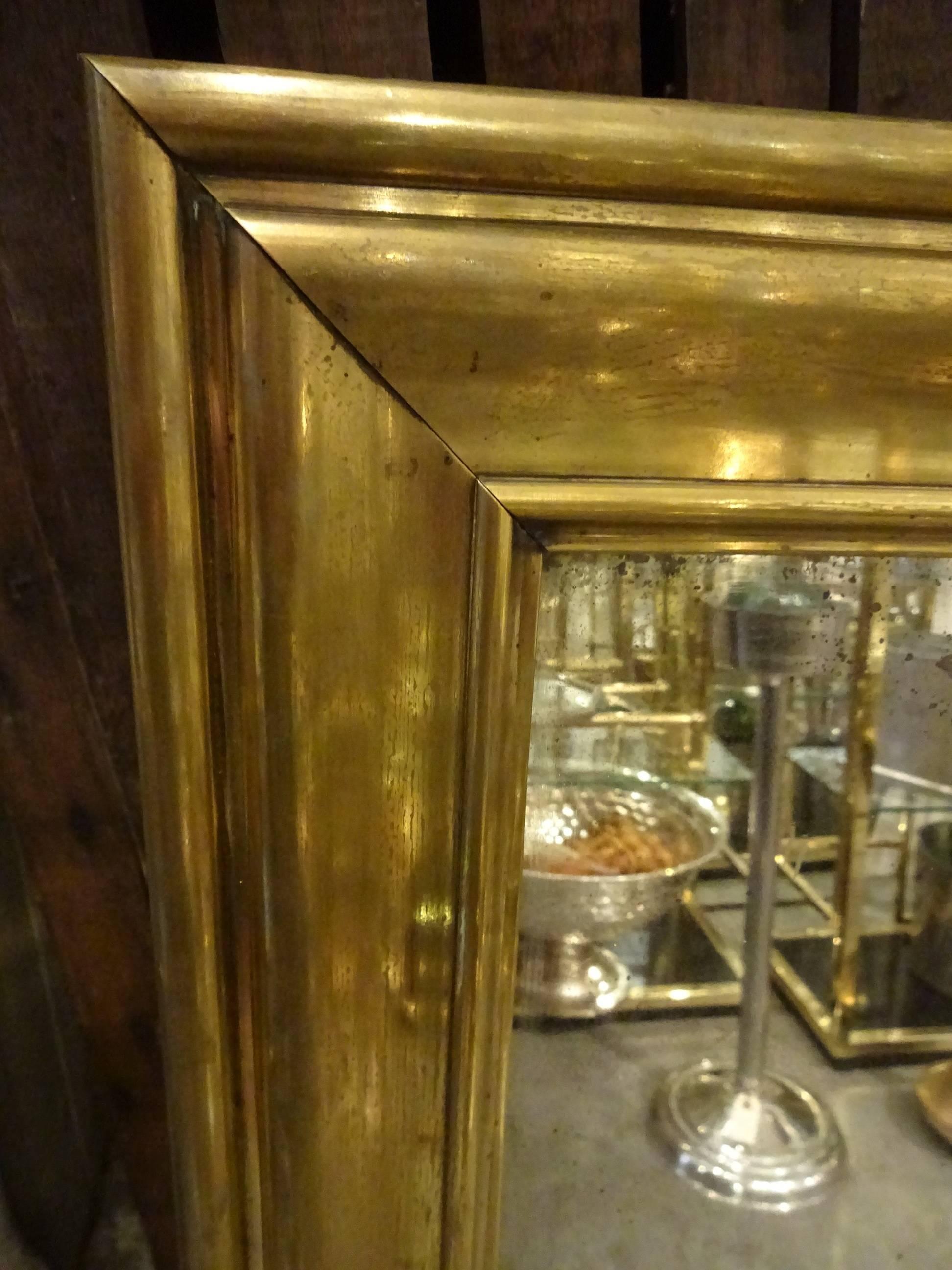 Gorgeous old French brass bistro mirror with the original mercury mirror.

 