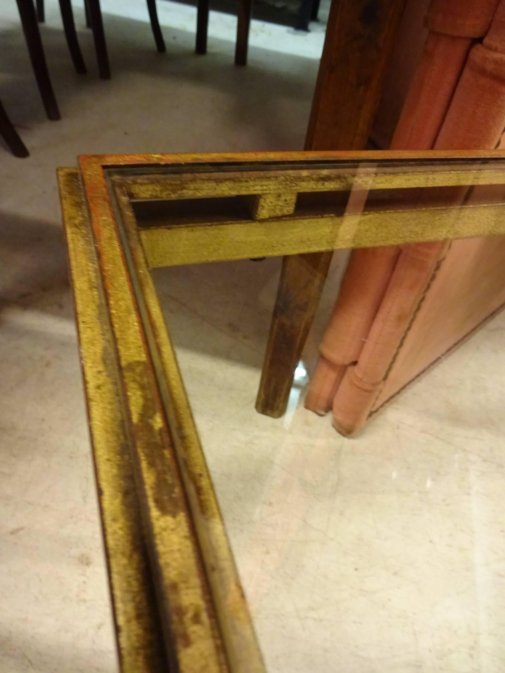 Beautiful and elegant French Maison Ramsey coffee table in gilt iron and glass tabletop.

