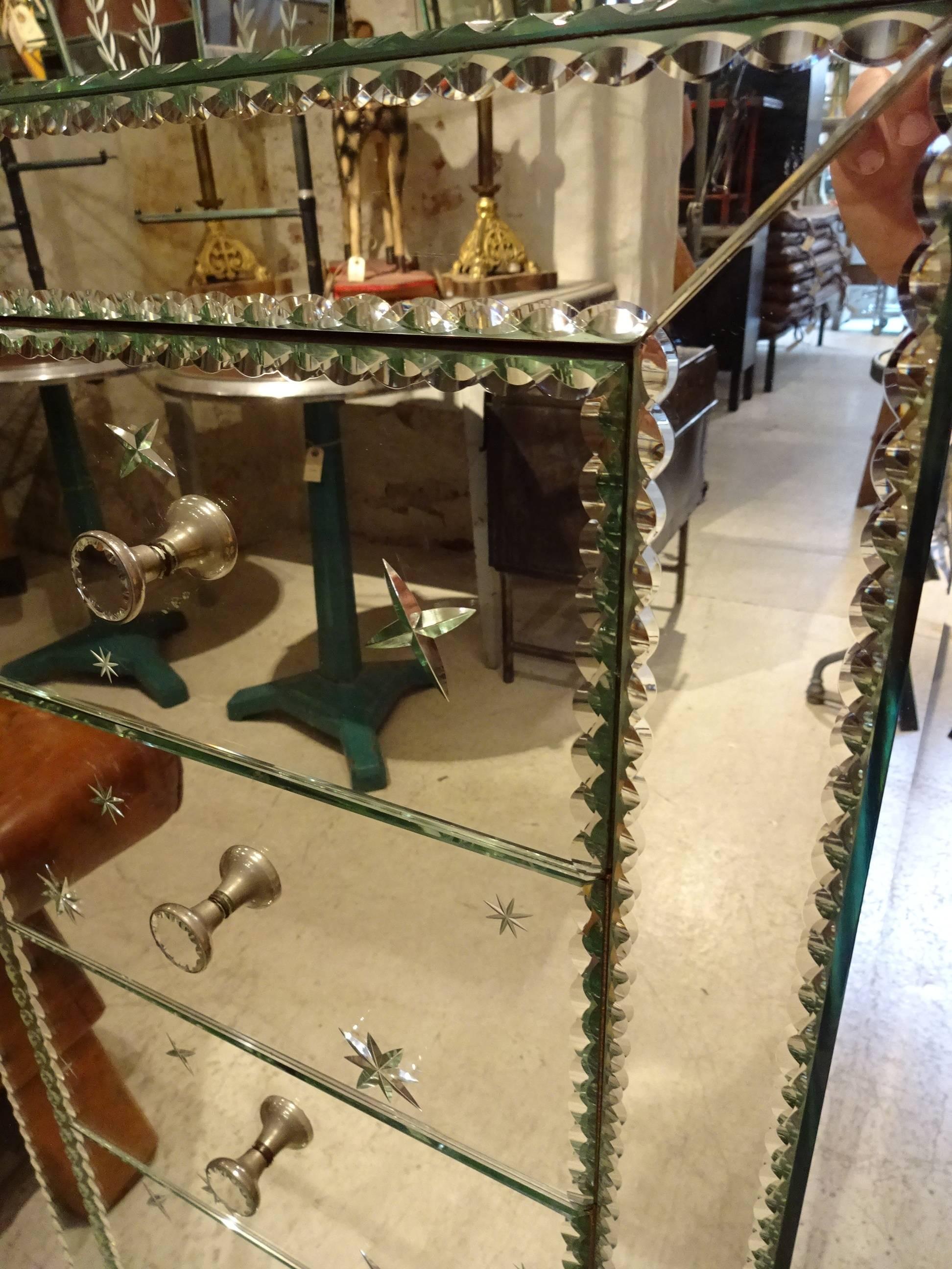 Great French dresser, completely covered in mirrored glass. The dresser has five drawers, each with an elegant cut-glass knob as a handle. The dresser is in very good condition.

