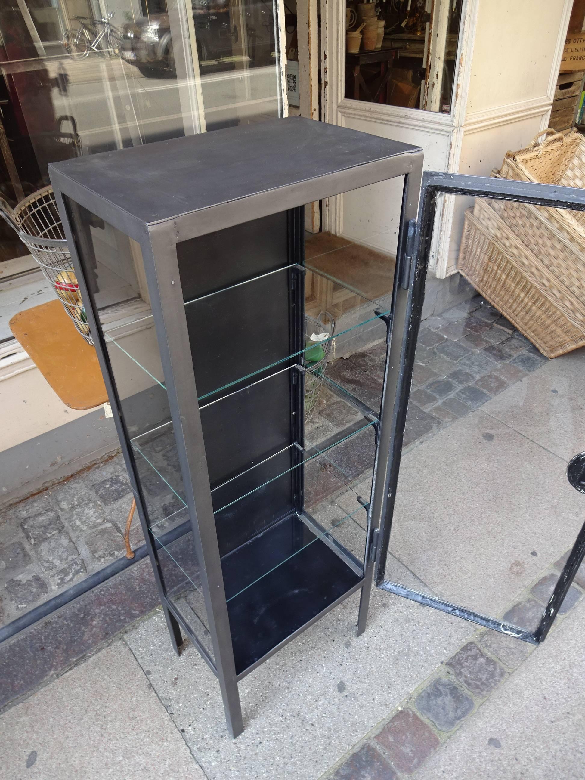 Super vintage French metal display cabinet, originally used for storage in a doctor’s practise.
This smaller compact cabinet is treated, polished and lacquered, and is not only a handsome item, but also very practical, with the three adjustable