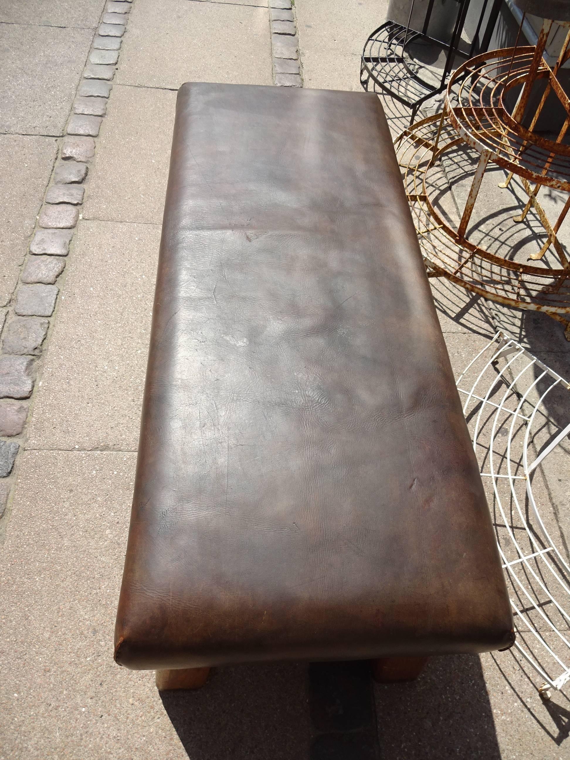Cool vintage French dark leather bench from an old gym hall wooden base. Fabulous as bench, coffee table, gallery seating or in a boutique.

