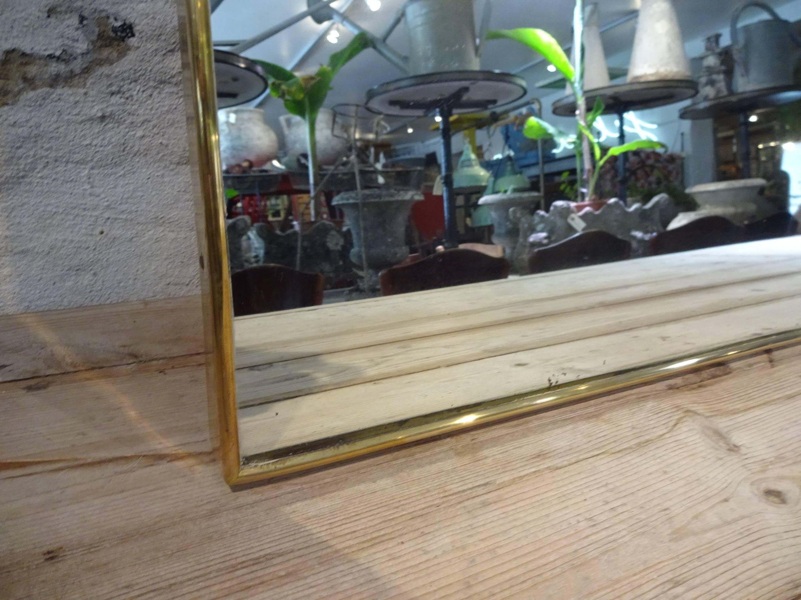 Huge and beautiful Mid-Century Italian brass mirror in a simple and elegant frame. Gorgeous shape.

