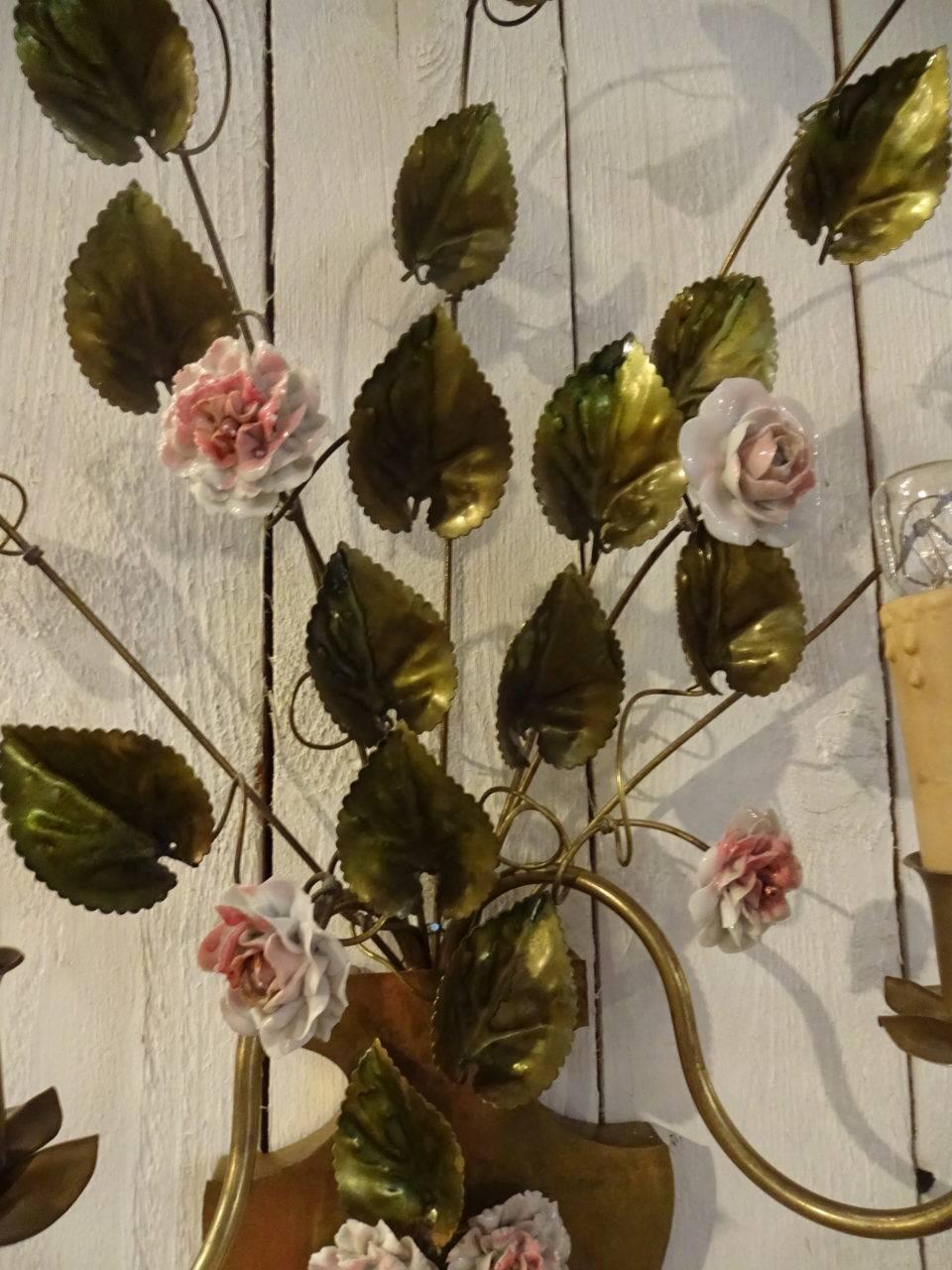 A pair of gorgeous French lamps or sconces, from circa 1950. The pair is made of brass and each with two arms for light as well as numerous small pink/white handmade porcelain flowers and small leaves in brass.

Measures: H 50 x W 35 x D 15 cm.