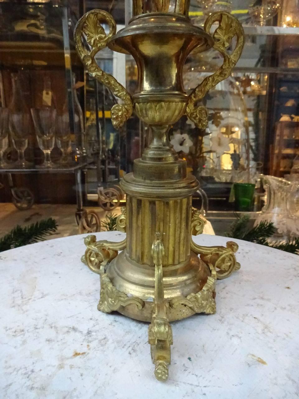 Gorgeous antique French church candlestick / candelabra in gilded bronze. Prettily decorated with white opaque glass lilies, and can hold 9 candles.