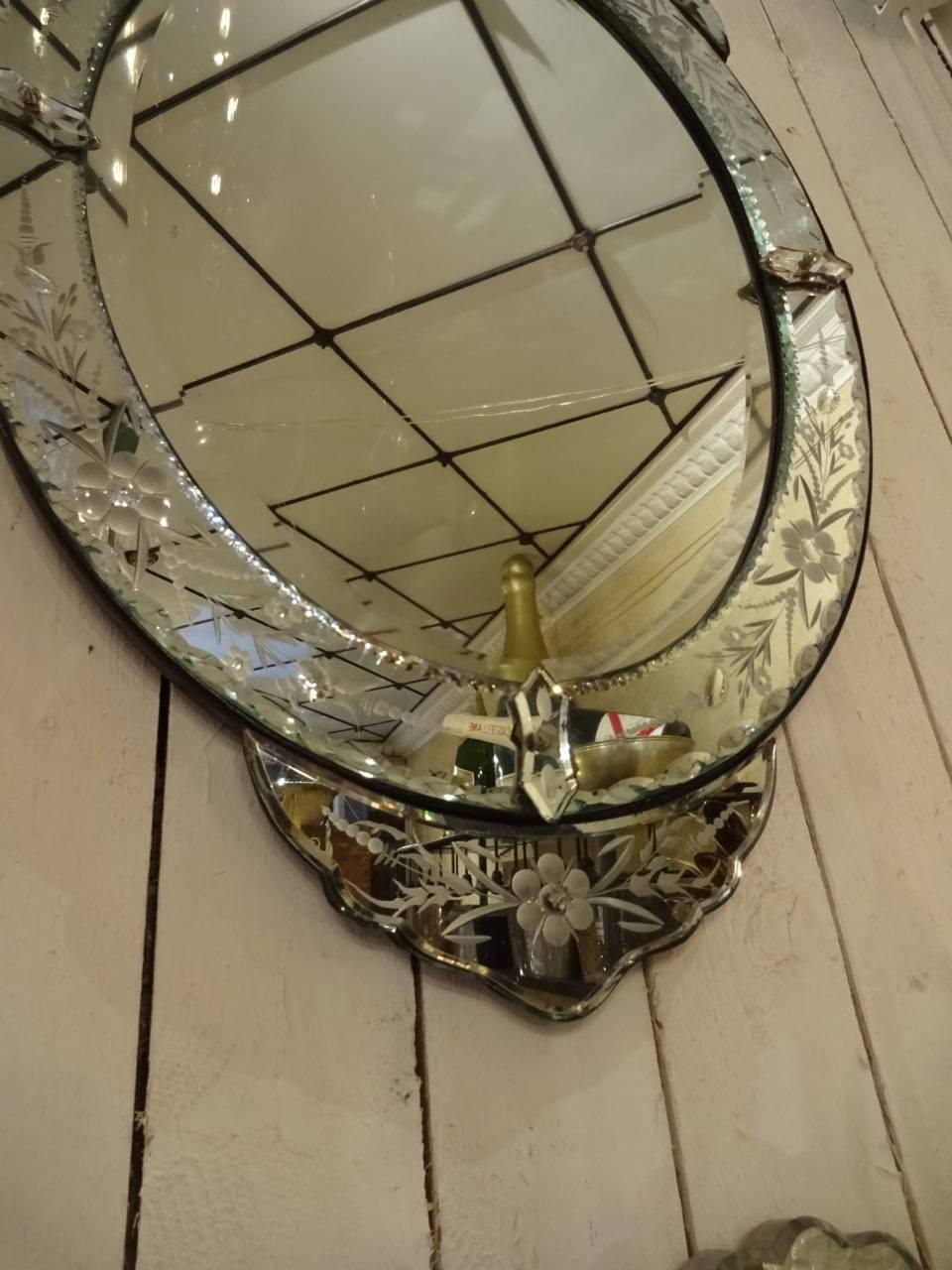 Gorgeous Venetian mirror from France, with fabulous cut mirrored glass and etchings. Pretty top of frame.