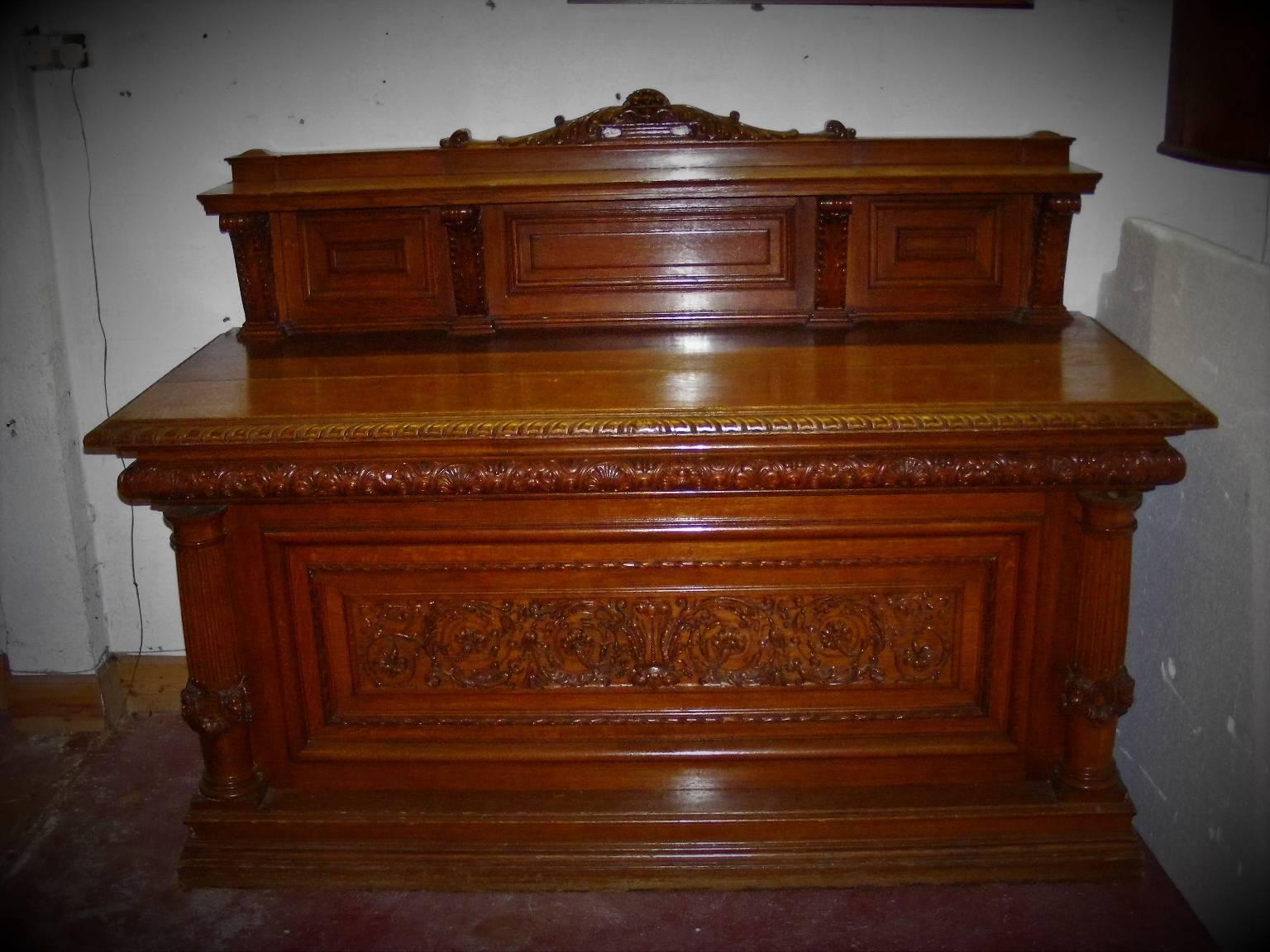 An important and majestically carved late Victorian, circa 1900 country house sideboard. The central feature depicting the Prince of Wales feathers emerging from a coronet flanked with generous scrolls and carved foliage with a harvest of fruit. The