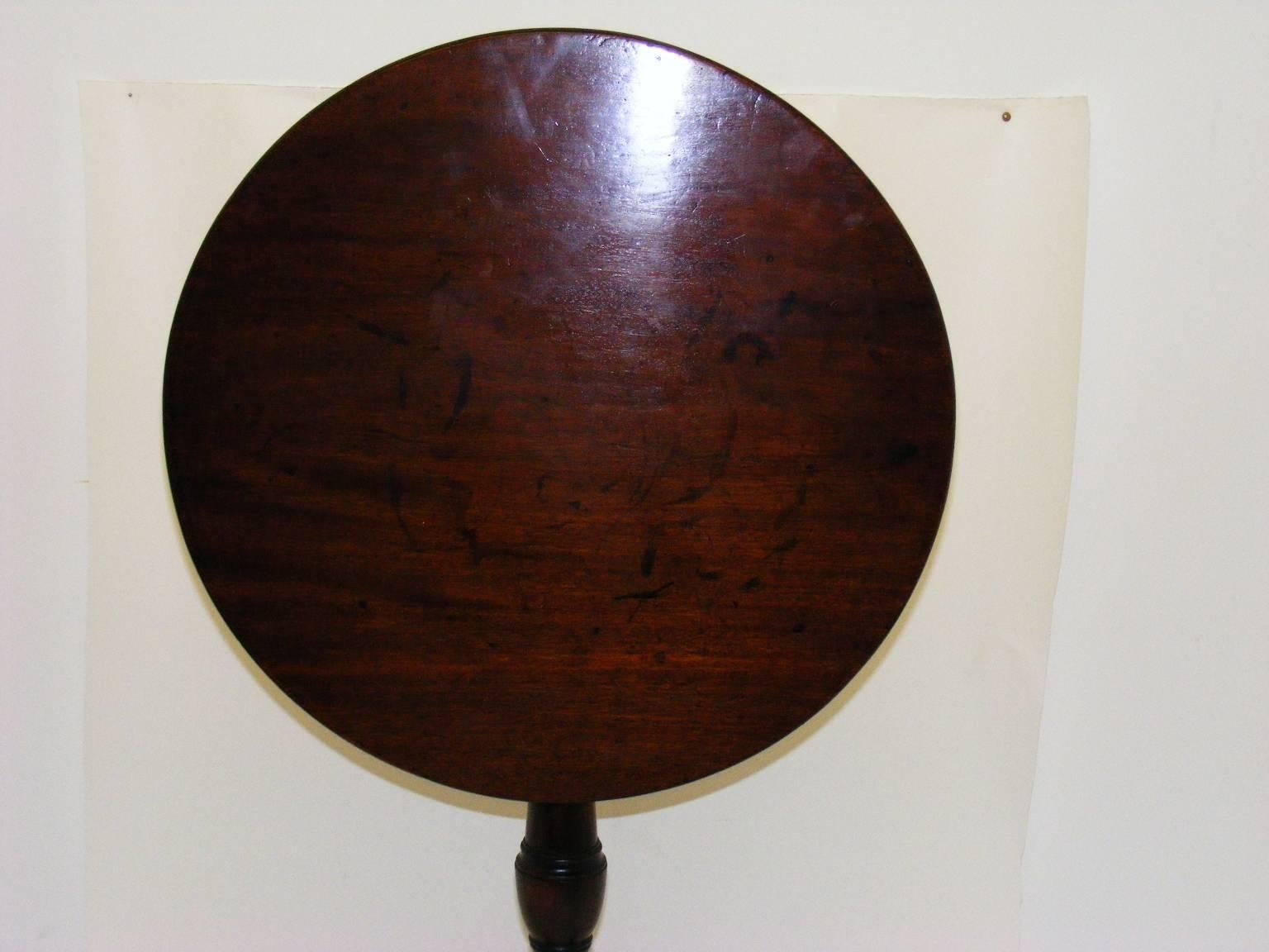 This is a lovely example of a small Georgian tilt-top table in fine untouched original condition. The top, which is made from rich warm grain mahogany with good patina, is mounted on a elegantly shaped column with tripod legs and slipper