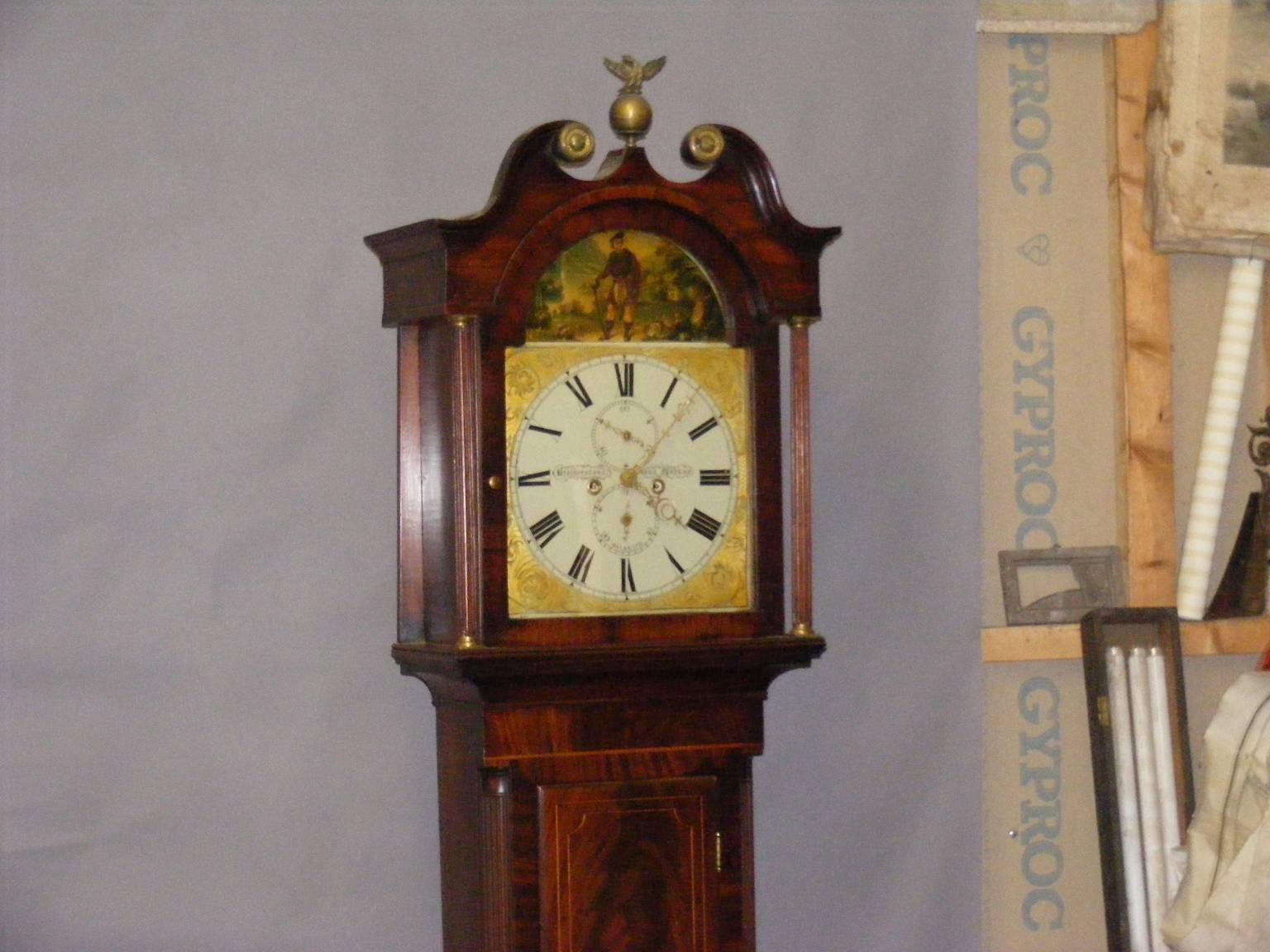 An antique Scottish mahogany grandfather clock maker Brotherston Mackay, Dalkeith, circa 1830.

The hood, with its swan necked pediment terminating in brass capitals, is centered with a finial of an eagle mounting a globe. It has a lockable door