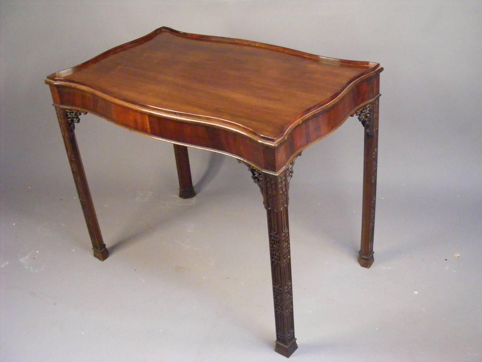 A superb and rare mahogany serpentine centre table, circa 1890 in the classical revival style.

This table is a rare find indeed. It is beautifully finished on four sides all of serpentine shape. The top with its raised gallery and cross banded