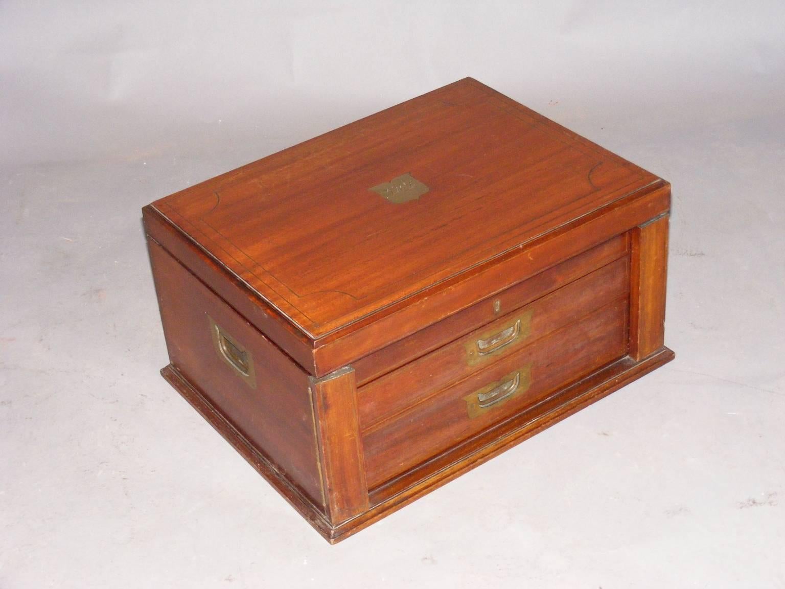This is an exceptionally fine cabinet box with brass stringing to the hinged lid that opens to reveal a well with green baize lined trays. There are two drawers each with brass countersunk handles. The drawers contain removable lined trays and can